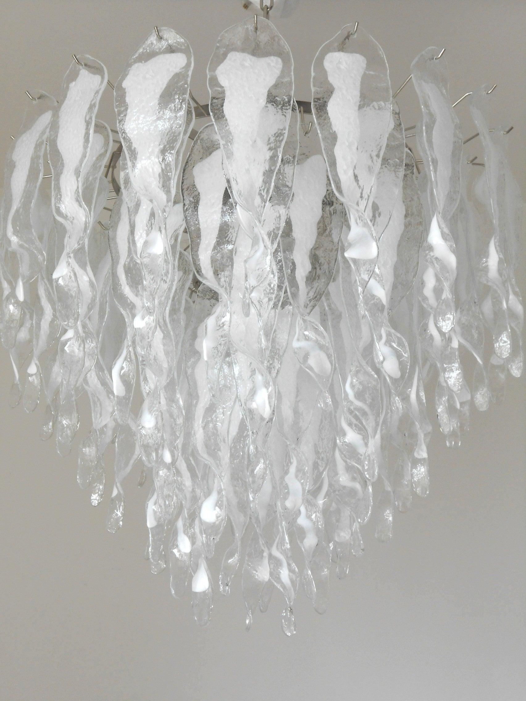 Italian chandelier shown with milky white and clear Murano glasses hand blown to form beautiful dangling stalactite shaped glasses, mounted on chrome finish frame / Designed by Fabio Bergomi for Fabio Ltd, inspired by Mazzega / Made in Italy
13