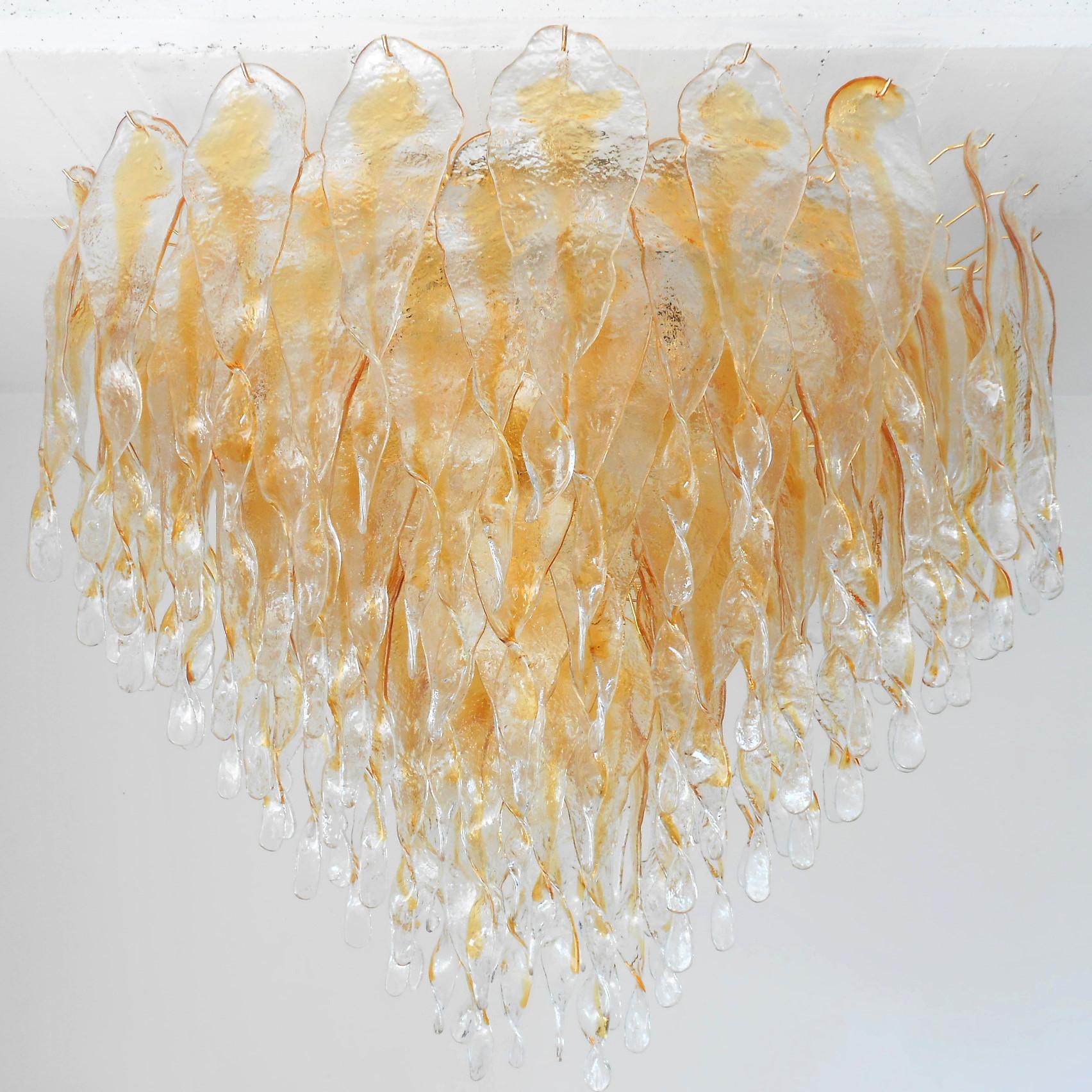 Italian chandelier shown with amber and clear Murano glasses hand blown to form beautiful dangling stalactite shaped glasses, mounted on chrome finish frame / Designed by Fabio Bergomi for Fabio Ltd, inspired by Mazzega / Made in Italy
21 lights /