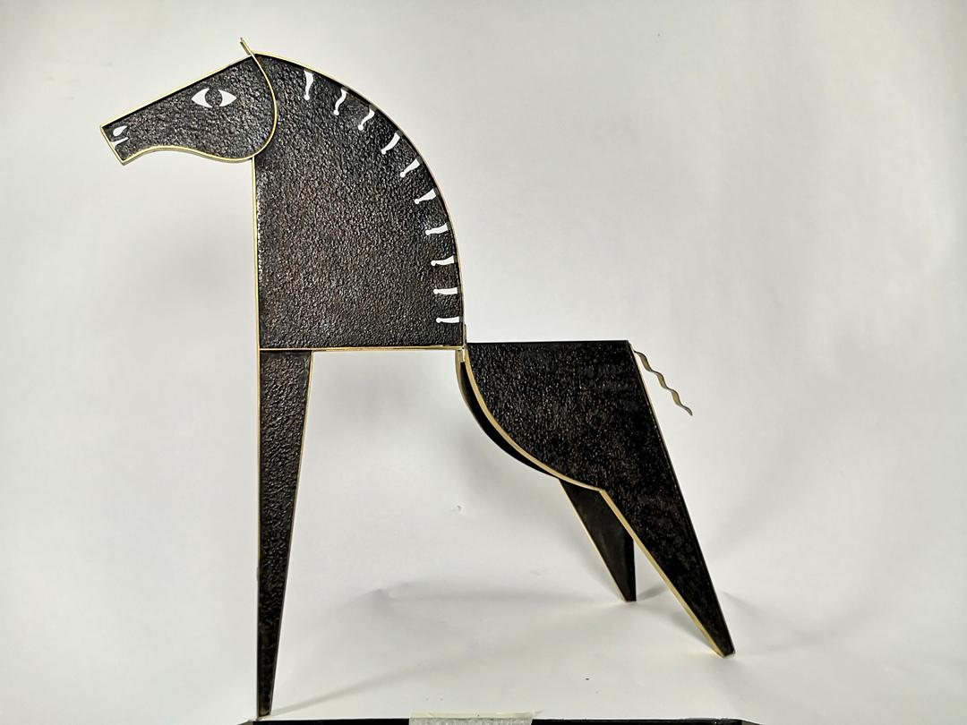 This elegant sculpture depicts a stallion horse - in the modernist style of the European Art Deco ouvre. The very high quality handmade metalwork of patinated, different metals, iron and brass was made by the hungarian Laszlo Pal Horvath goldsmith,