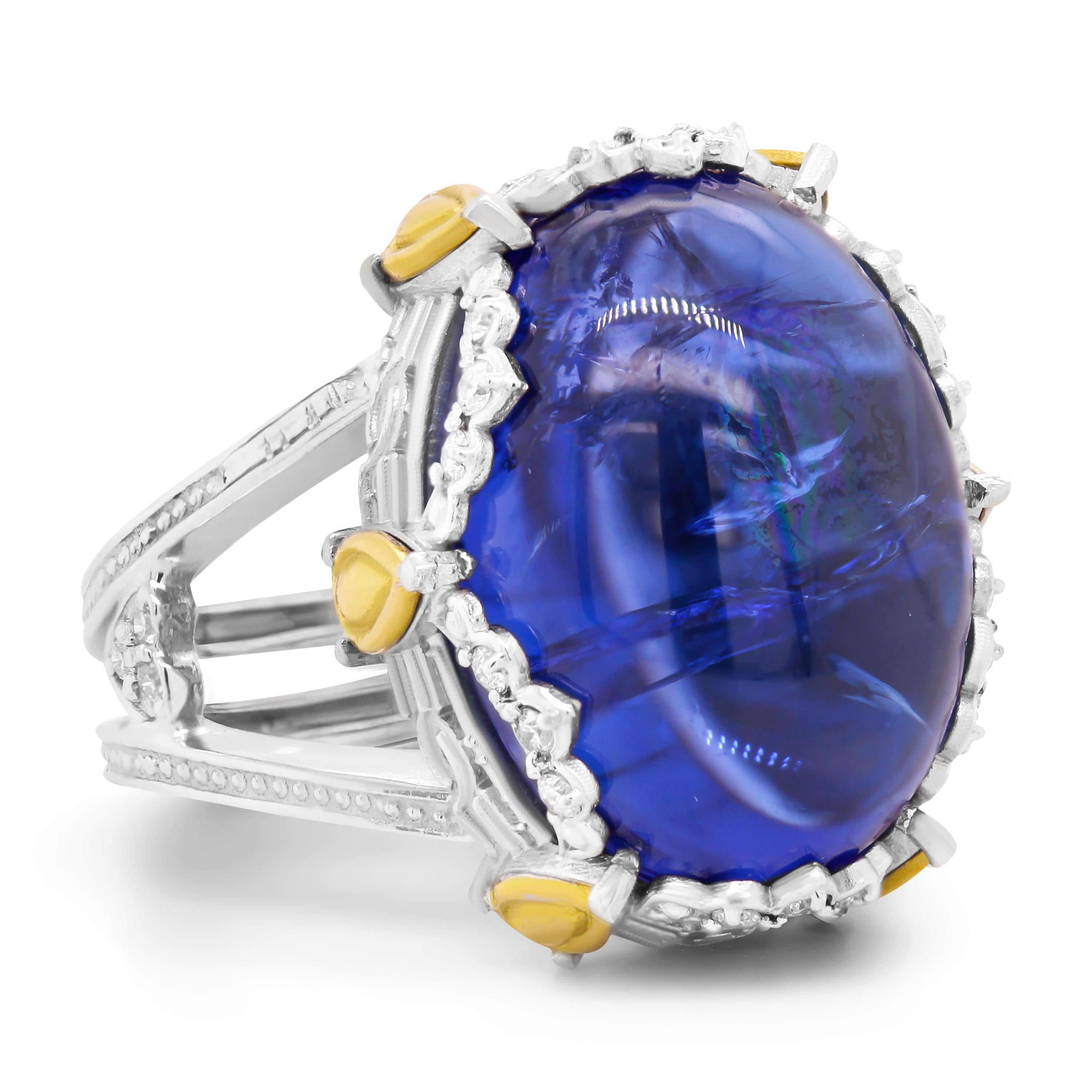 Stambolian 18K Two Tone Gold Diamond AAA Quality Cabochon Tanzanite Dome Ring

This one-of-a-kind ring features an AAA quality, vibrant blue, Cabochon Tanzanite center with diamonds and gold design work all across the edges.

Apprx. 18.20 carat