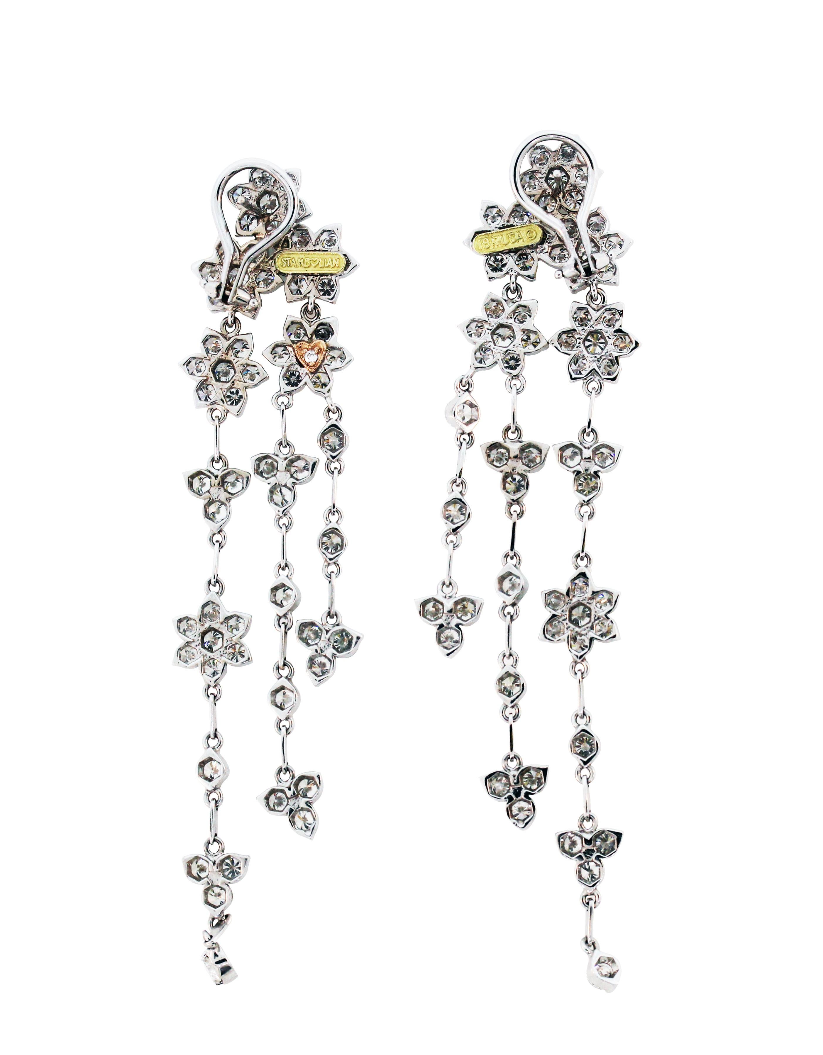 Stambolian 18K White Gold and Diamond Clusters Chandelier Dangle Earrings

6.14 carat G color VS Clarity diamonds

Post-omega backs used for security.

Earrings are 3 inches in length x 0.6 inch width

Signed Stambolian and has the Trademark