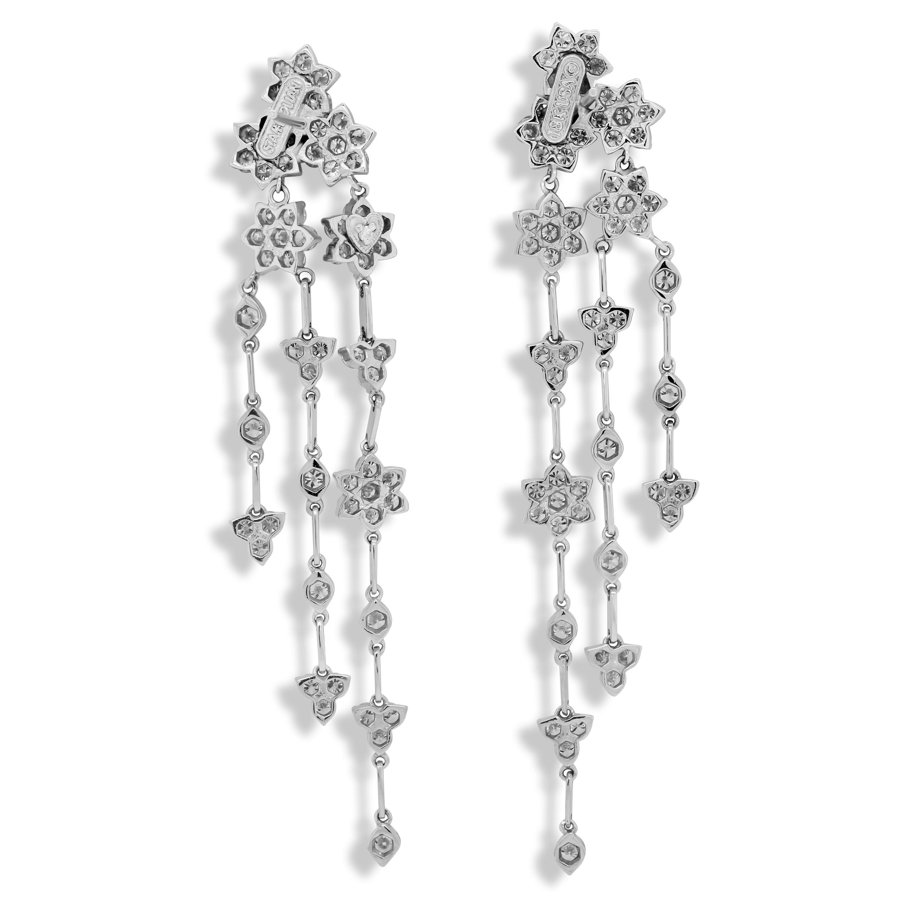 Stambolian 18K White Gold and Diamond Clusters Chandelier Dangle Earrings

6.14 carat G color VS Clarity diamonds

Post-omega backs used for security.

Earrings are 3 inches in length x 0.6 inch width

Signed Stambolian and has the Trademark