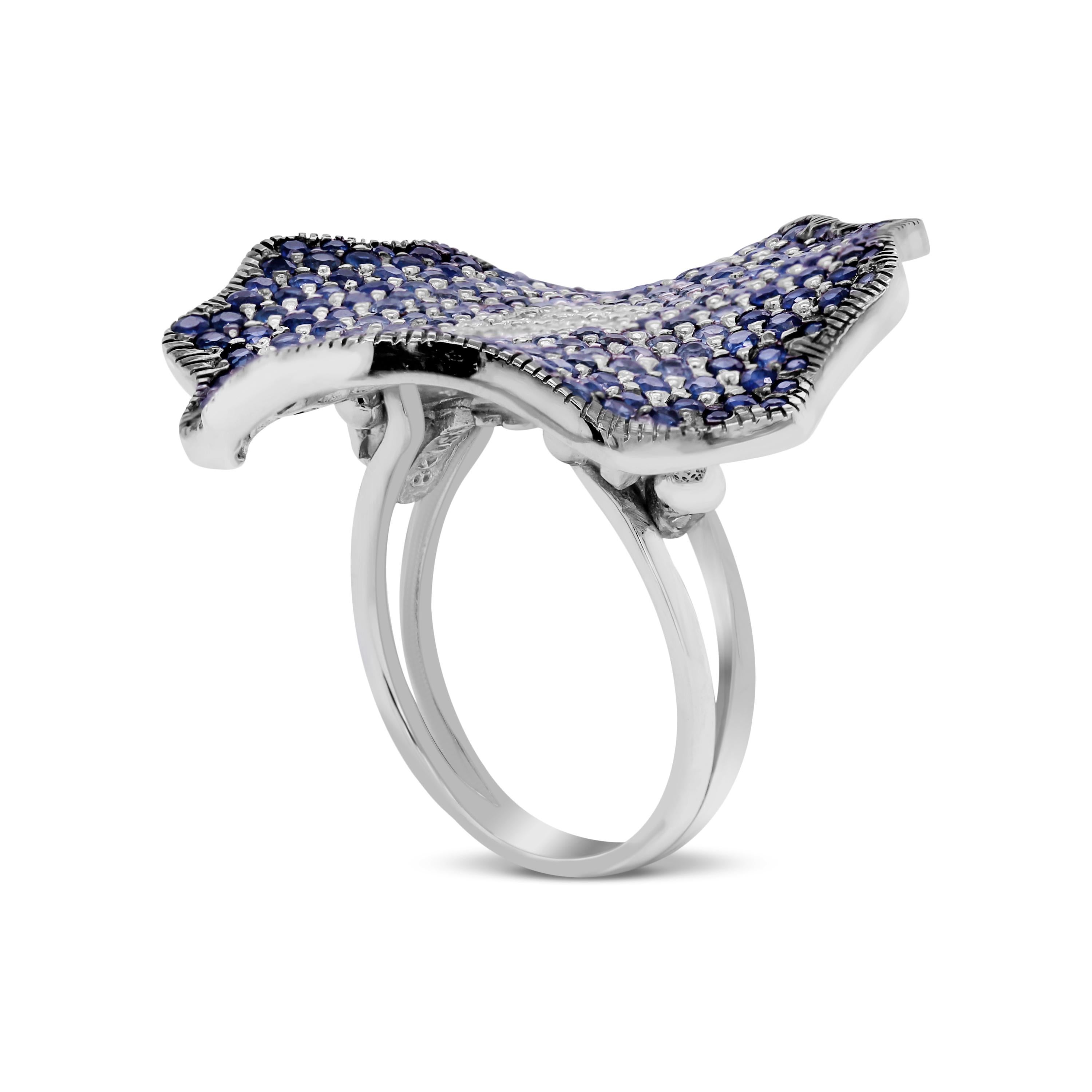 Stambolian 18K White Gold Shaded Dark to Light Blue Sapphire and Diamond Ring

This state-of-the-art ring by Stambolian features and curved, abstract shaped design with sapphires beginning with the darker on the outside, gradually shading lighter