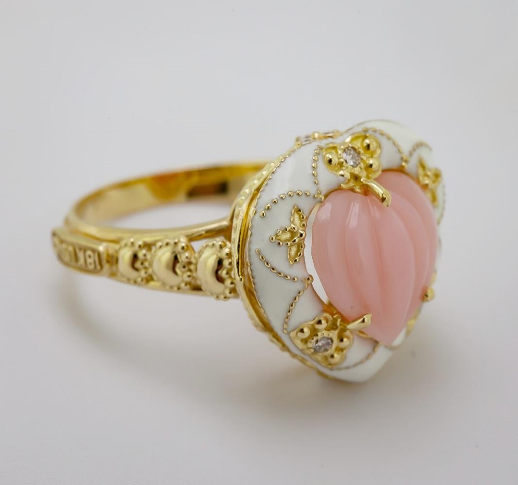 Centering one carved pink Peruvian opal melon heart cabochon, 11 X 11 mm, accented by (10) full-cut diamonds, 0.20 ct. tw., VS, G-H, enhanced by white enamel, and gold bead tracery, set in an 18k yellow gold heart motif mounting, 17.3 X 2.6 mm,