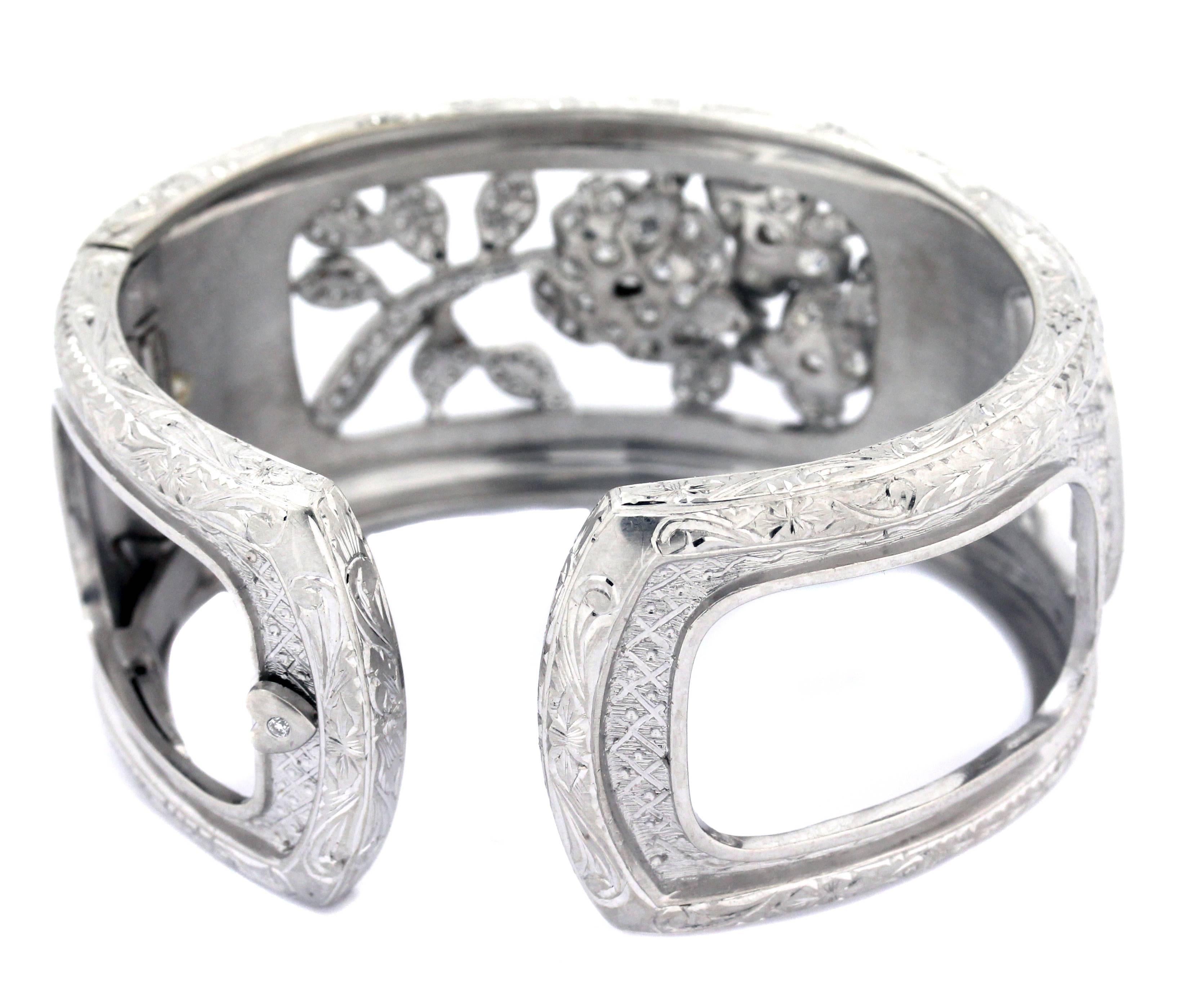 Estate 18K White Gold and Diamond Hand Engraved Floral Cuff Bracelet by Stambolian

This is the only one of its kind. Truly a work of art. The cuff is entirely hand made. The engravings on the face of the ring are all done by hand. 

The bracelet