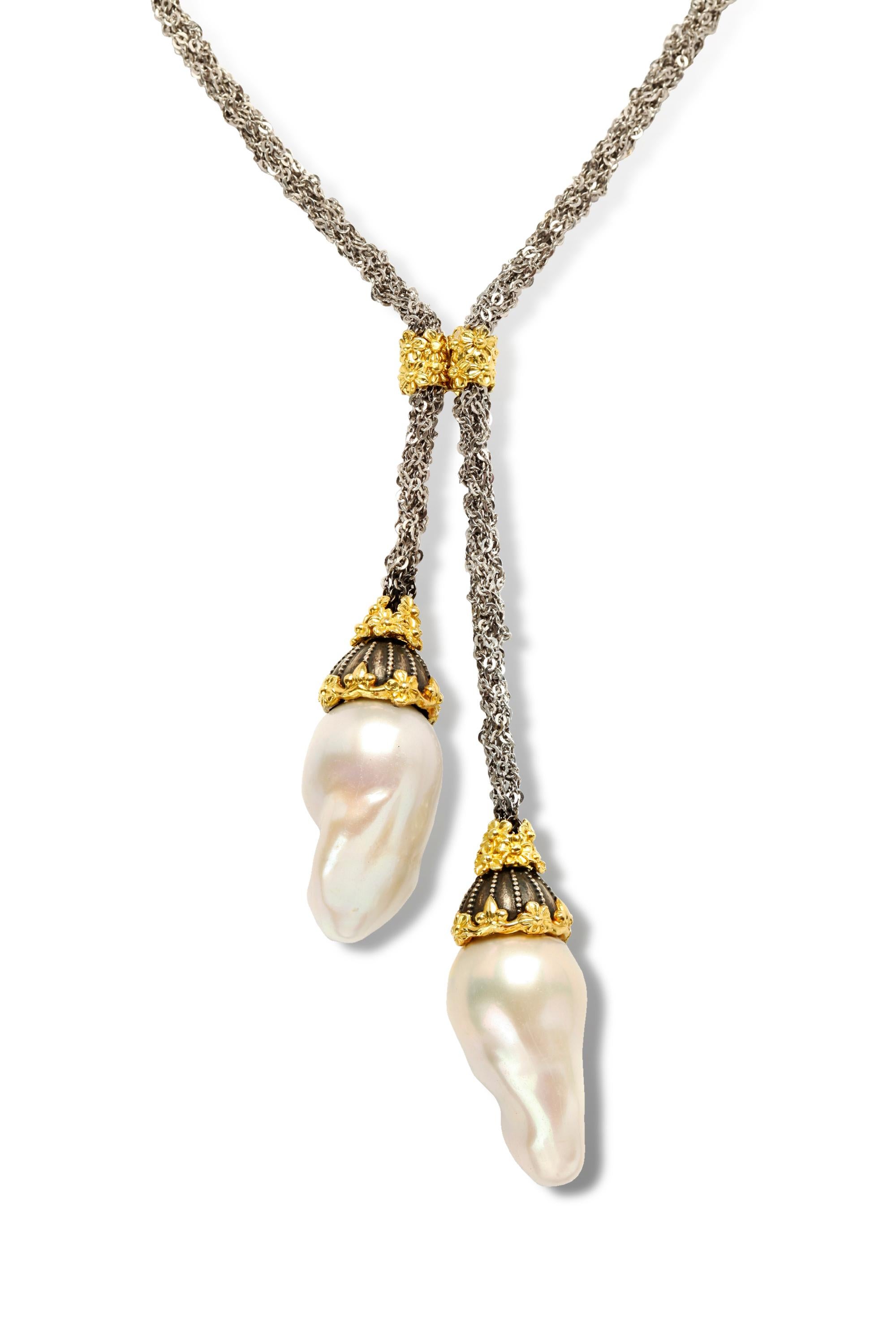 Stambolian Mesh Silver Chain and 18K Gold Baroque Pearl Drops Lariat Necklace 

This unique necklaces features a gorgeous mesh type chain that is connected in the center by a gold floral design

The design leads to two drops with fresh water baroque