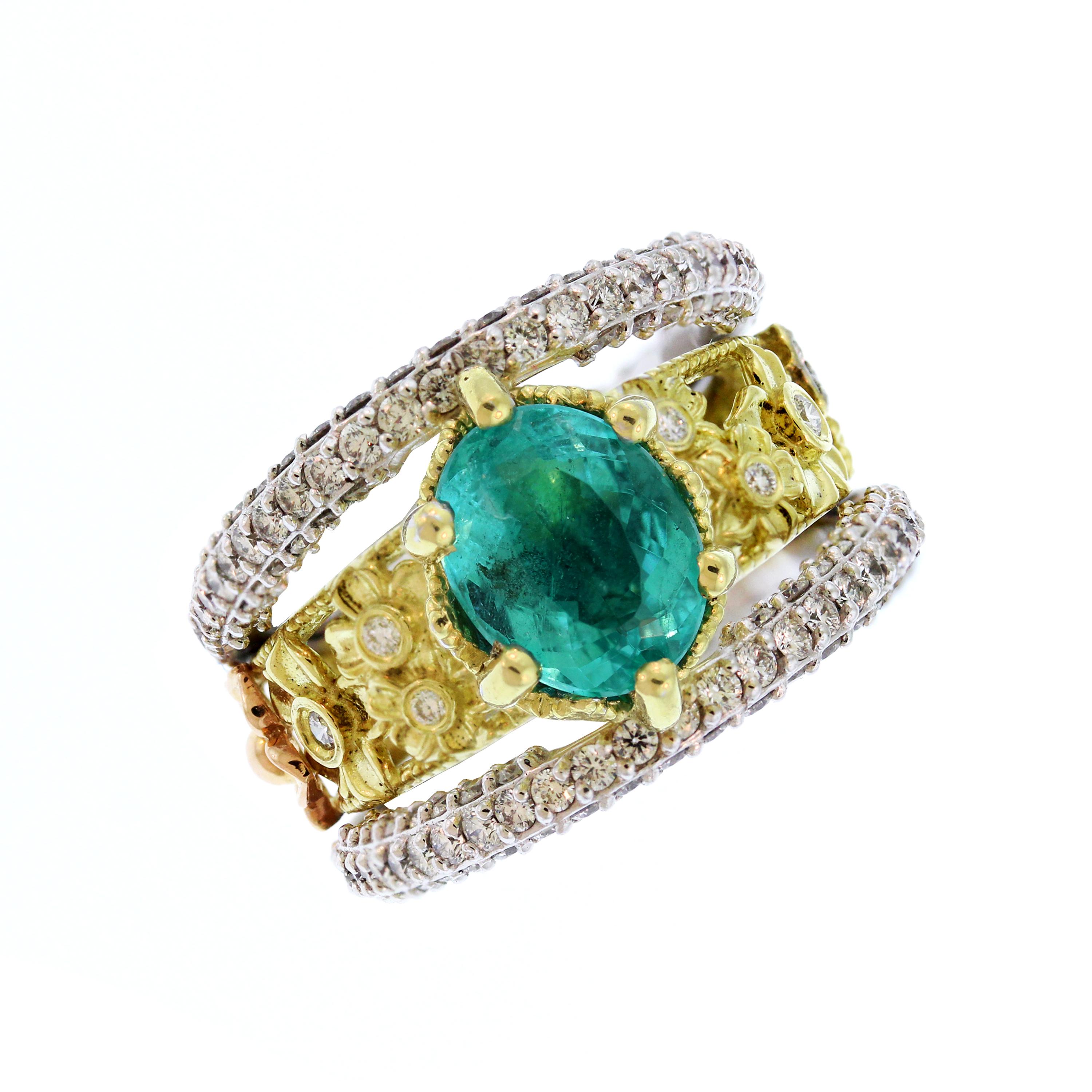 Stambolian 18K Tri-Color Gold Paraiba Copper Bearing Tourmaline Diamond Ring

This is a one of a kind ring with a stunning display of design work and craftsmanship. The ring itself has three sections. One done in yellow gold with flowers and two all