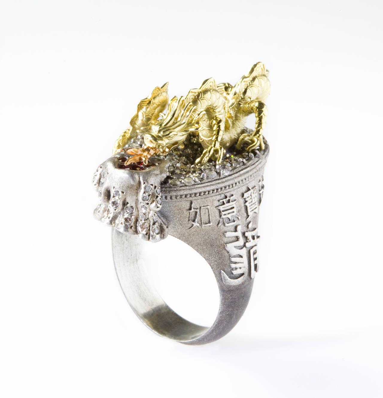 Stambolian Aged Silver 18K Gold Milky and White Diamond Dragon Ring

This ring features a Dragon with a snake's body, claws of an eagle, pigs nose, rabbits eyes, head of a camel, scales of the carp, deer horns, bull ears, tiger paws, a clams