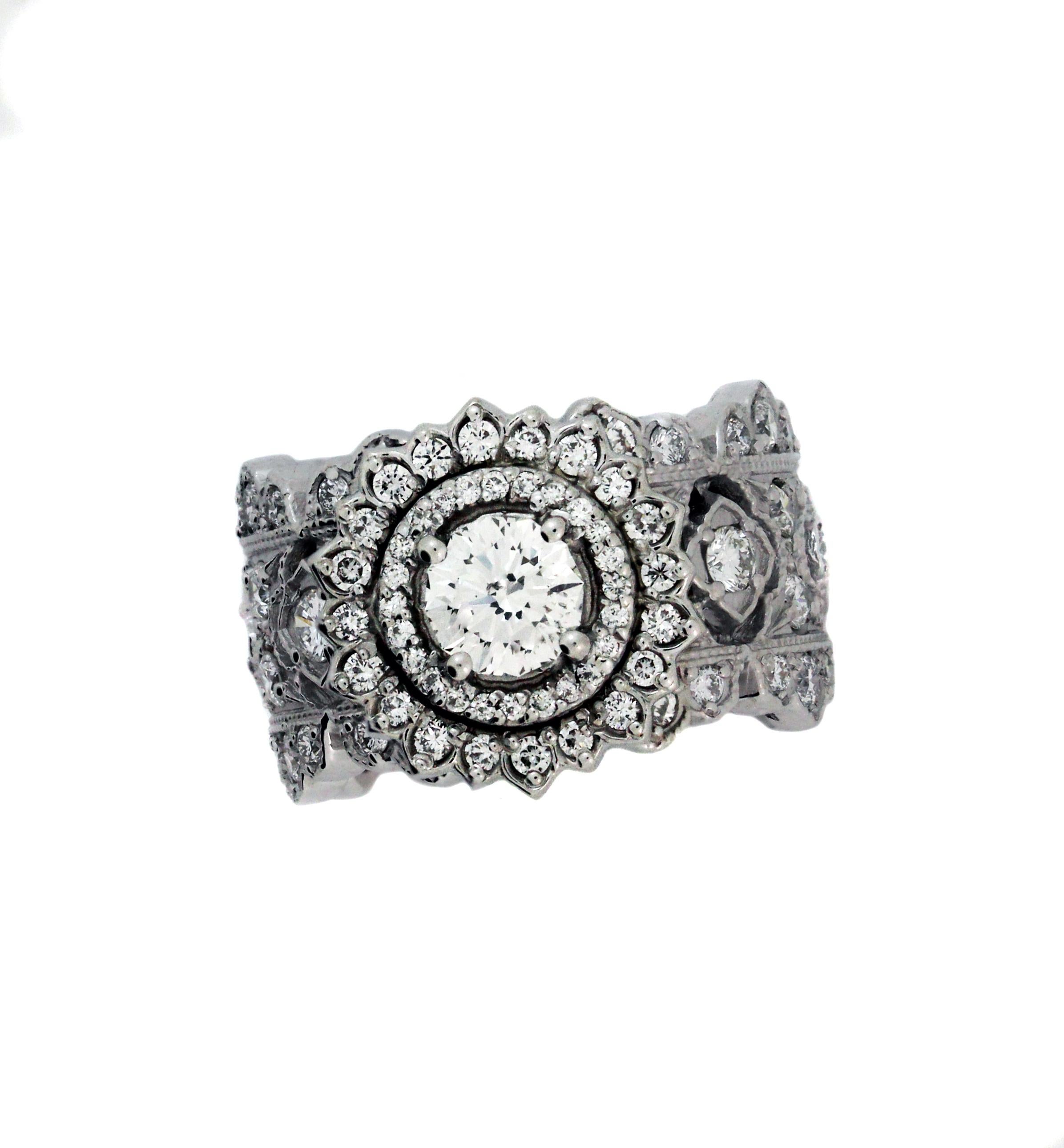 18K White Gold and Diamond Wide Band Ring with 0.71 carat Diamond Center

Center 0.71 carat diamond is G color, SI clarity and is surrounded by double diamond rows

Band has diamonds all throughout, from the Stambolian 