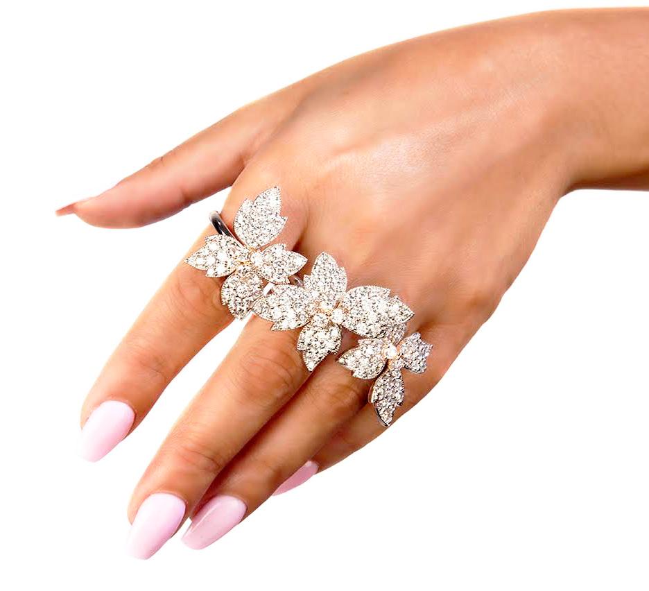 Stambolian 18 Karat White Diamond Three Finger Floral Motif Flowers Ring

12.88 carat G color, VS clarity diamonds are set throughout entire piece. This state of the art ring is a collectors piece! An original by American designer, Stambolian. Apart
