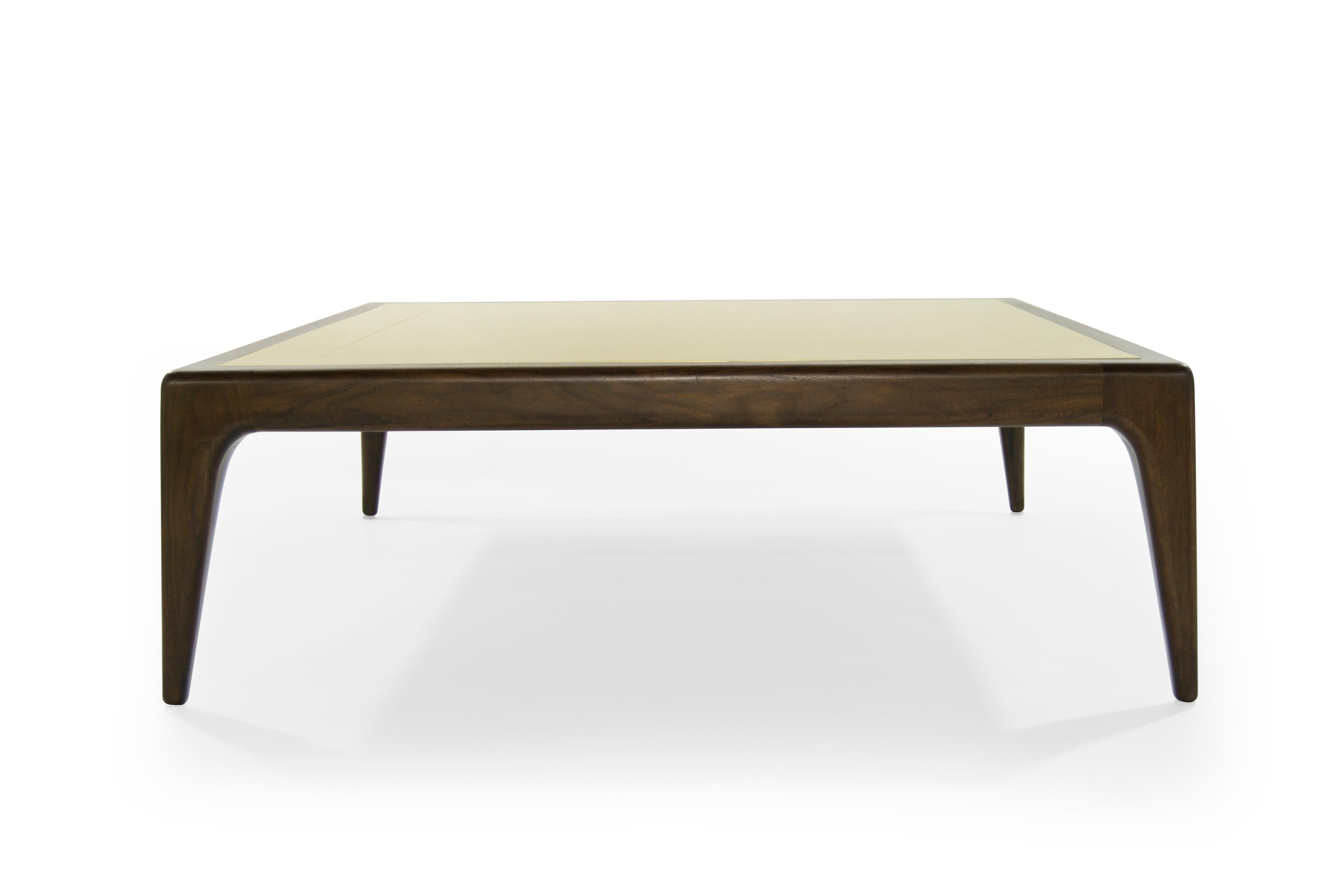 This modernist coffee table lets each material shine and play to its strength. Solid walnut is sculpted with organic curves and soft edges, so every connection looks seamless. The tabletop is inlaid with solid brass and decorated with linear seams.