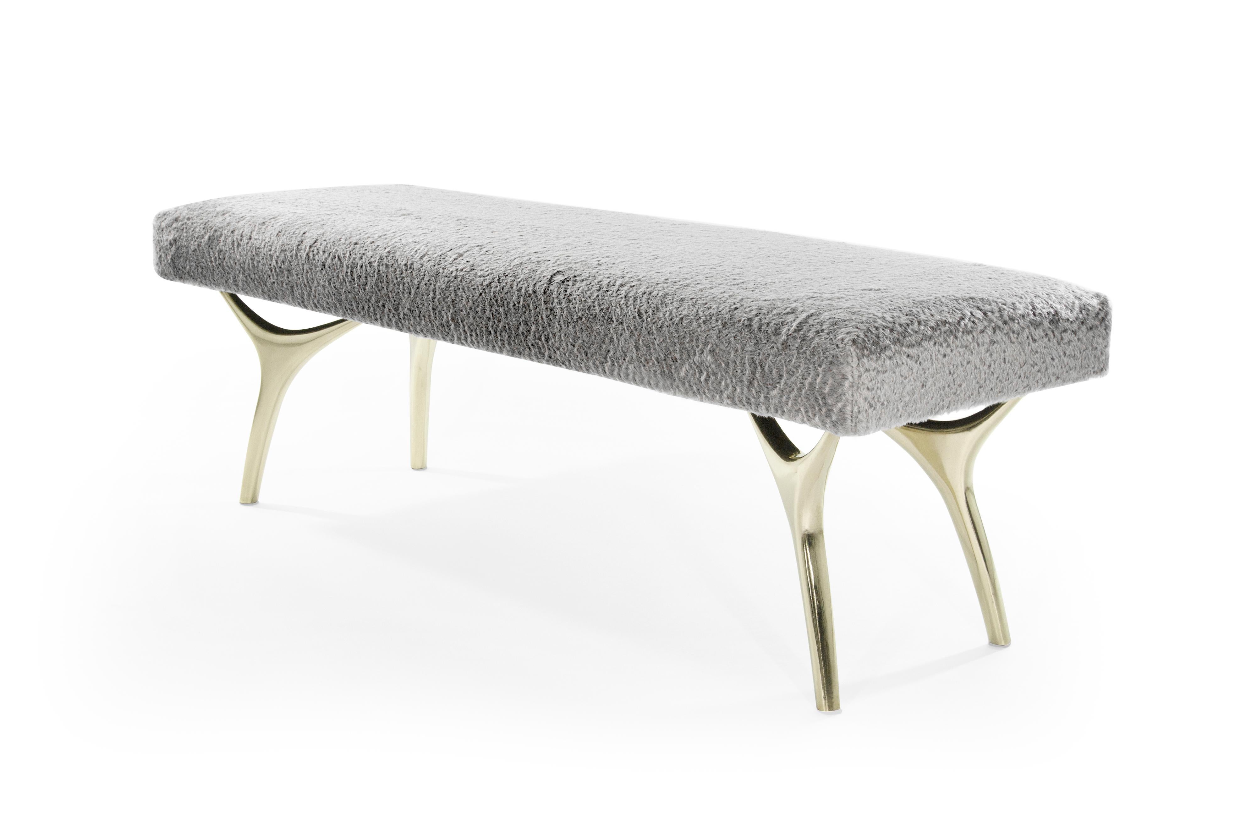 The Crescent Bench floats effortlessly, poised on brass fingertips. Inspired by 20th-century visionaries like Vladimir Kagan and Gio Ponti, this bench offers a unique perspective. The plush bench cushion is fully wrapped in soft silver mohair