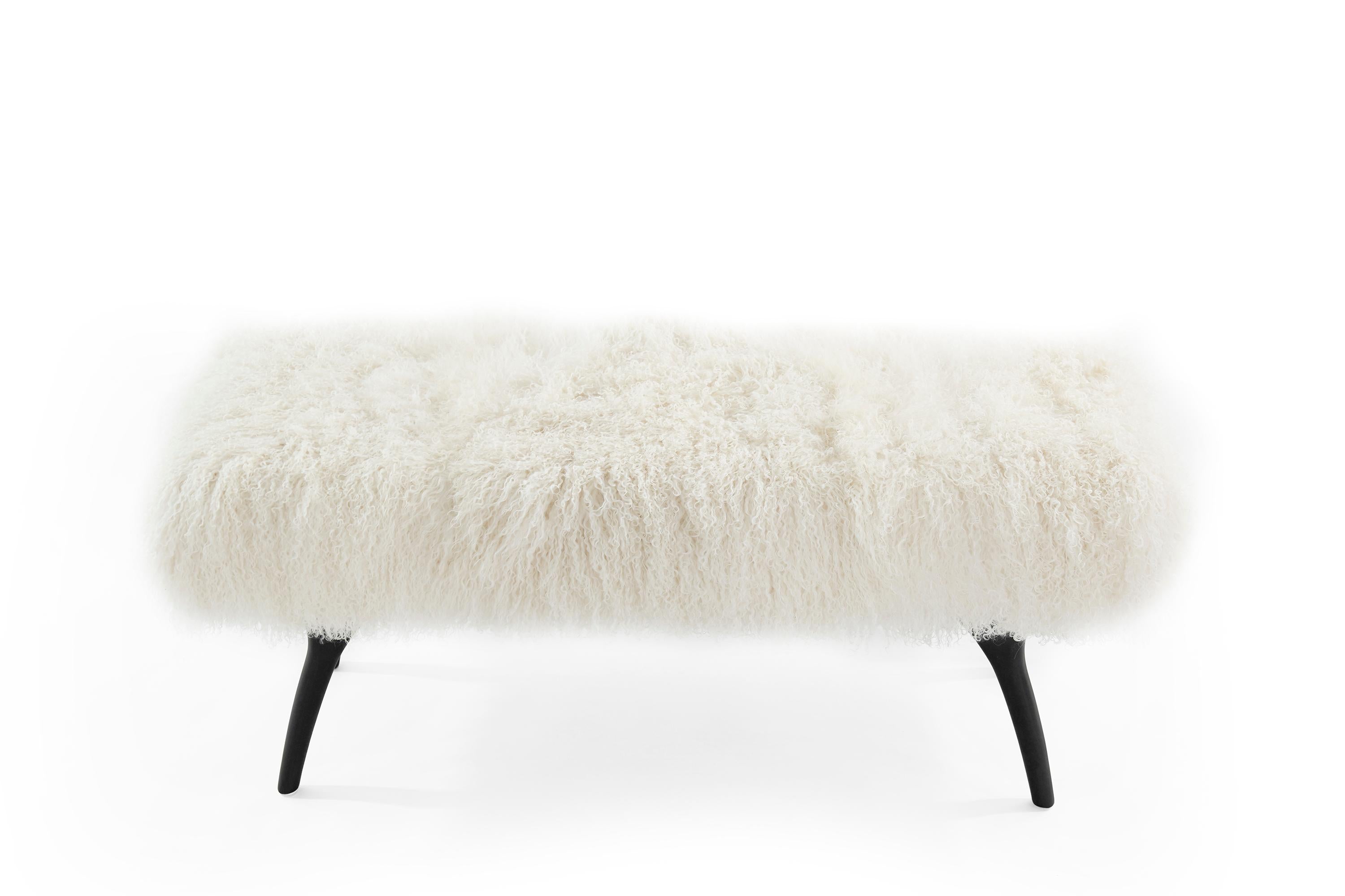 The Crescent Bench floats effortlessly, poised on bronze fingertips. Inspired by 20th-century visionaries like Gio Ponti and Vladimir Kagan, this bench offers a unique perspective. The plush bench cushion is shown upholstered in creamy Mongolian