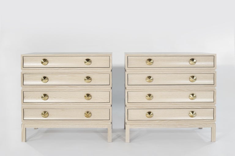 Stacked with confidence and lots of character. This set of two commodes pays homage to designer Paul Frankl with a rustic modern finish. Each drawer front is beautifully carved with curved edges that mirror its large, shaped brass pulls. The dresser