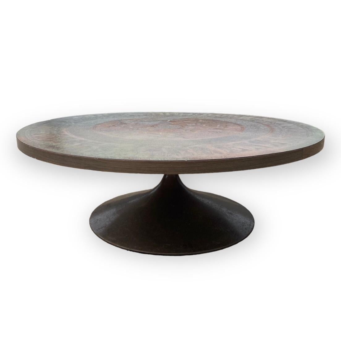 Vad Trevarefabrikk, Norwegian circular copper topped coffee table, with the ancient Egyptian style motif on a circular wine glass style metal base, with angle steel sub-frame, circa 1970

Condition Report

Slight discolouration area of verdigre