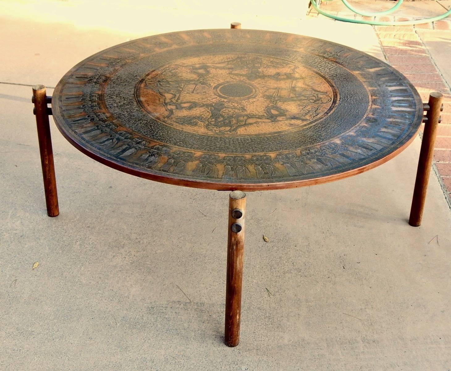 Norwegian coffee table with stamped copper top in neo-Egyptian themes. Crafted by Vad Trevare Fabric Norge, circa 1970. Base in solid, stained birch wood. Exposed wood joinery.
With patina and some fading on wood-otherwise in great original