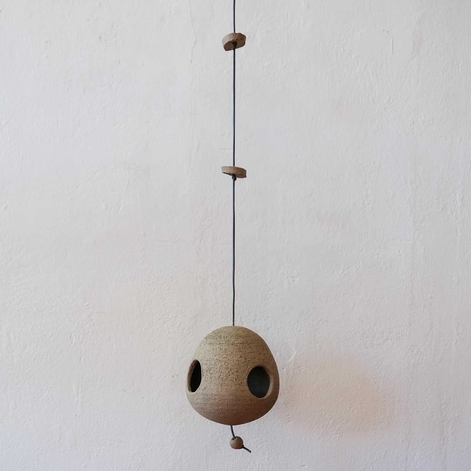 Ceramic birdhouse by Stan Bitters, for Hans Sumpf. Dual hole bird habitat with a small patch of moss. Stan Bitters is an California ceramics sculptor whose work was instrumental in shaping the organic modernist movement in the 1960s.  