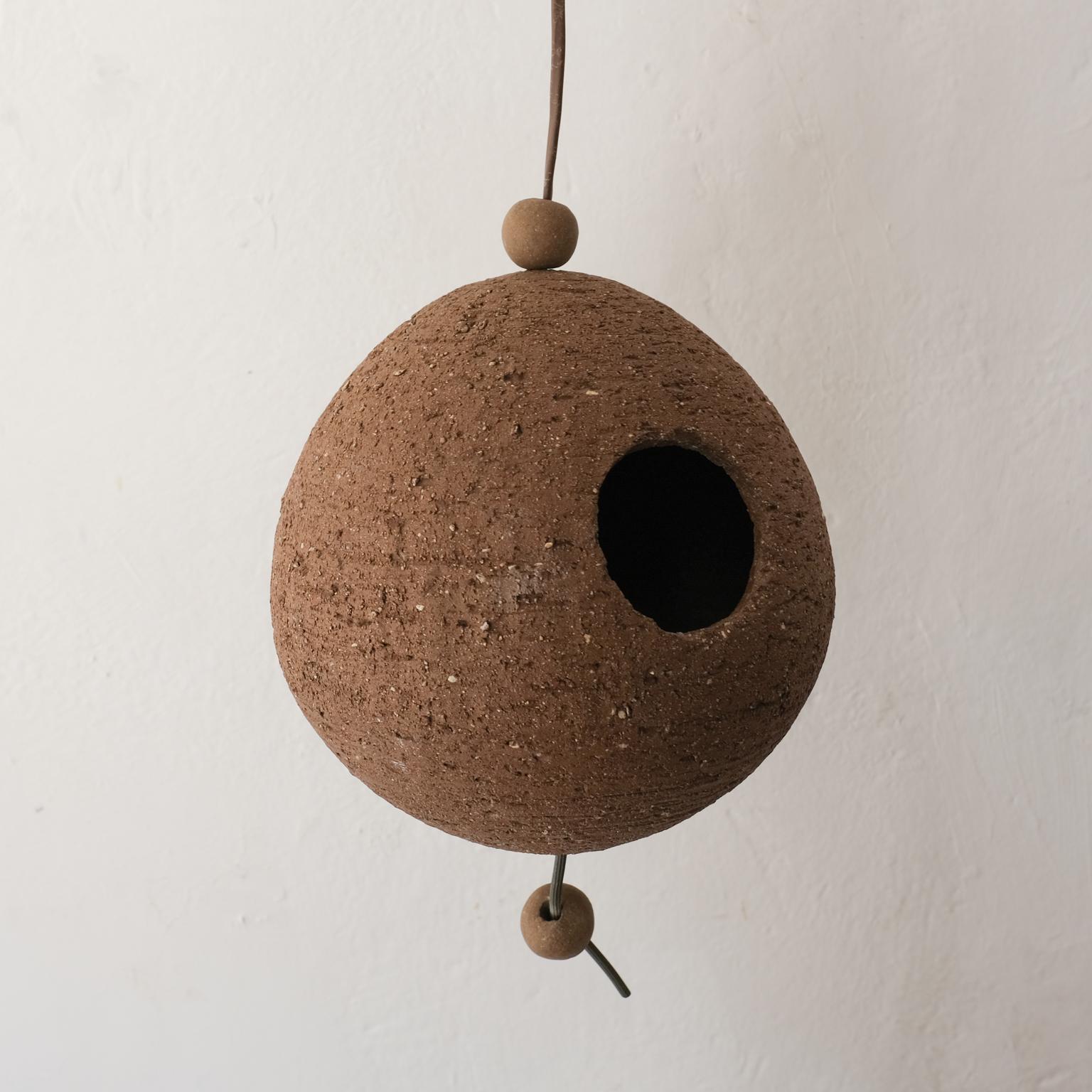 Vintage wheel-thrown birdhouse by California ceramicist Stan Bitters for Hans Sumpf. 

The length including the hanging cord is 36