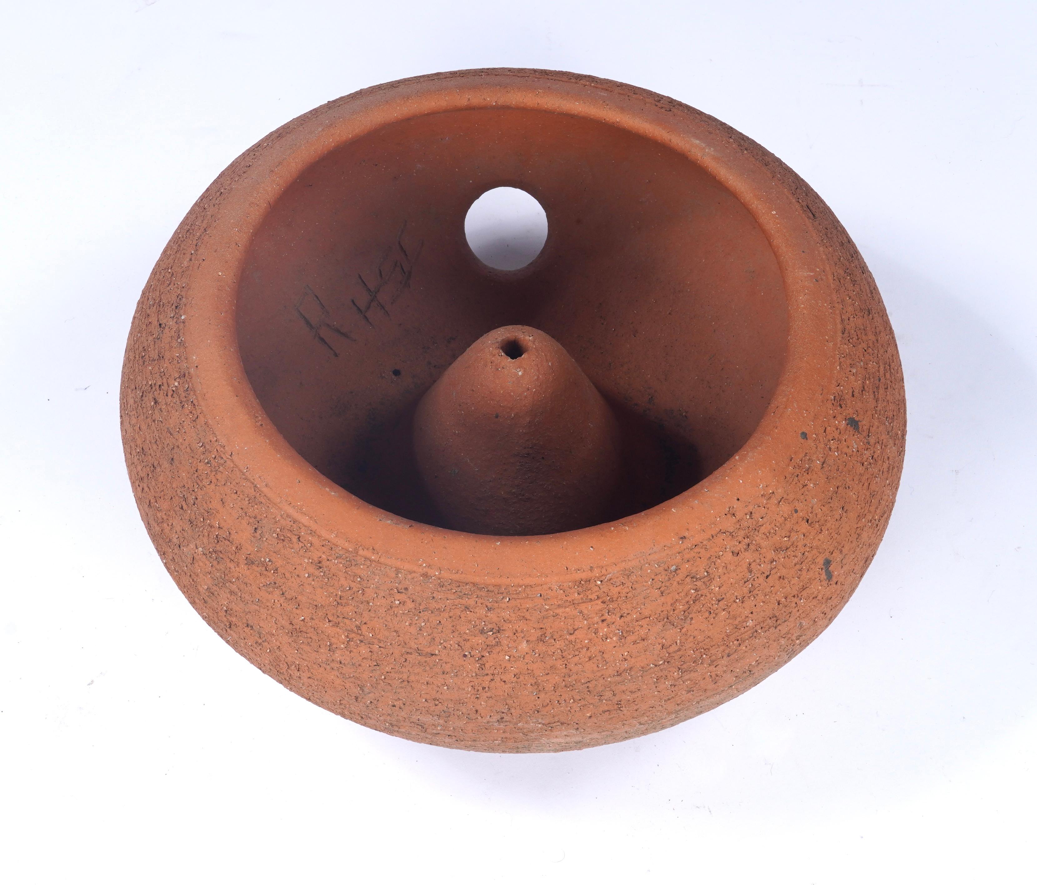 Ceramic garden hose holder pot in red clay designed by California ceramic artist Stan Bitters known for his large scale installations, art pottery and large ceramic planters. He designed this for the ceramic company Hans Sumpf and had a kiln there
