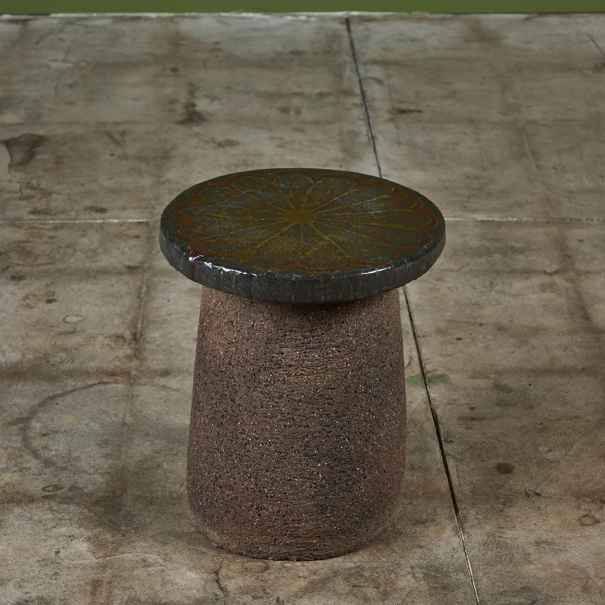 Mushroom stool or side table by Stan Bitters, USA. This piece features a round glazed ceramic top with floral motif and an unglazed stoneware base. Perfect as a petite side table, foot stool or garden element.

Dimensions
12