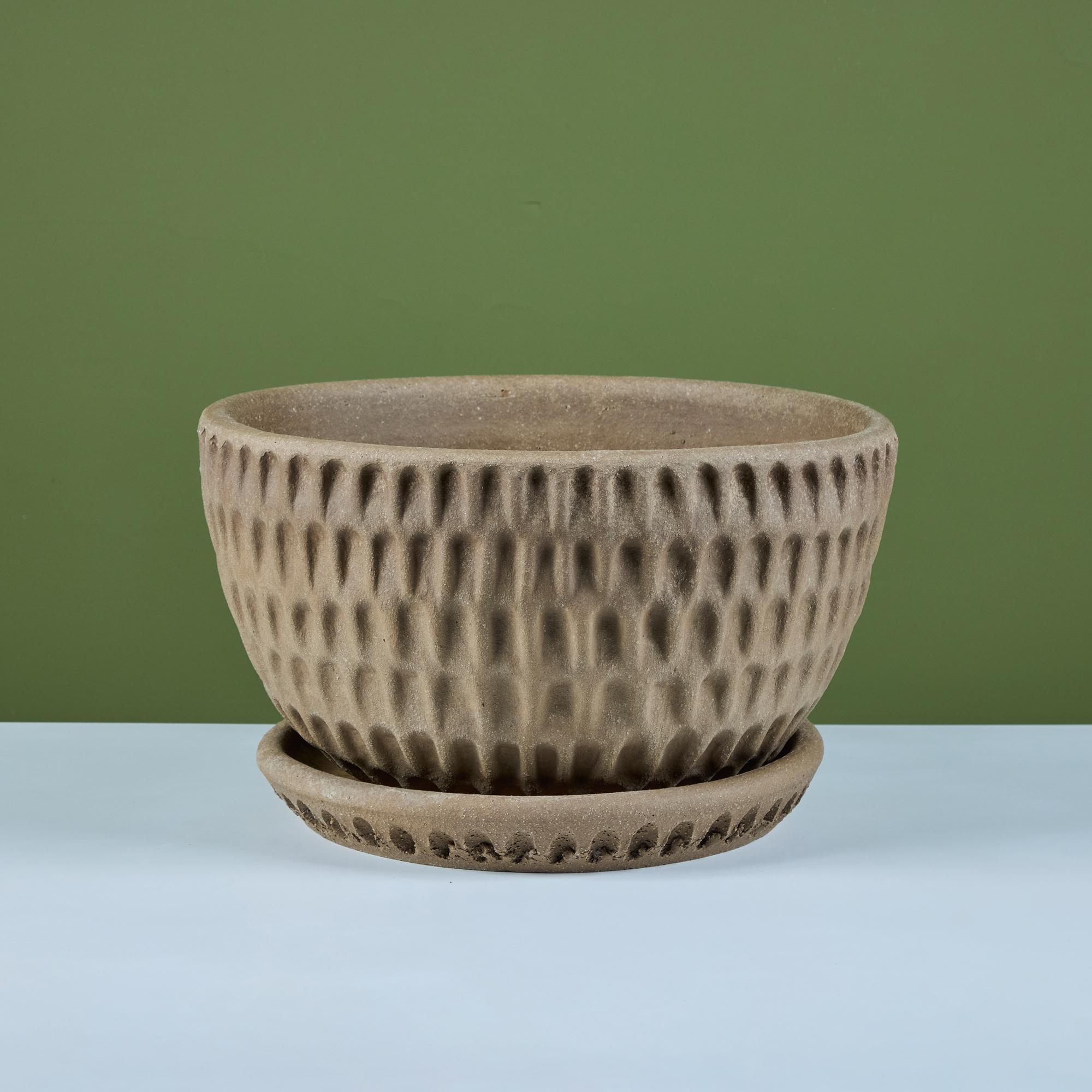 Round hand formed pot by California artist Stan Bitters for Hans Sumpf, c.1995, USA. This clay pot features a textured exterior in a 