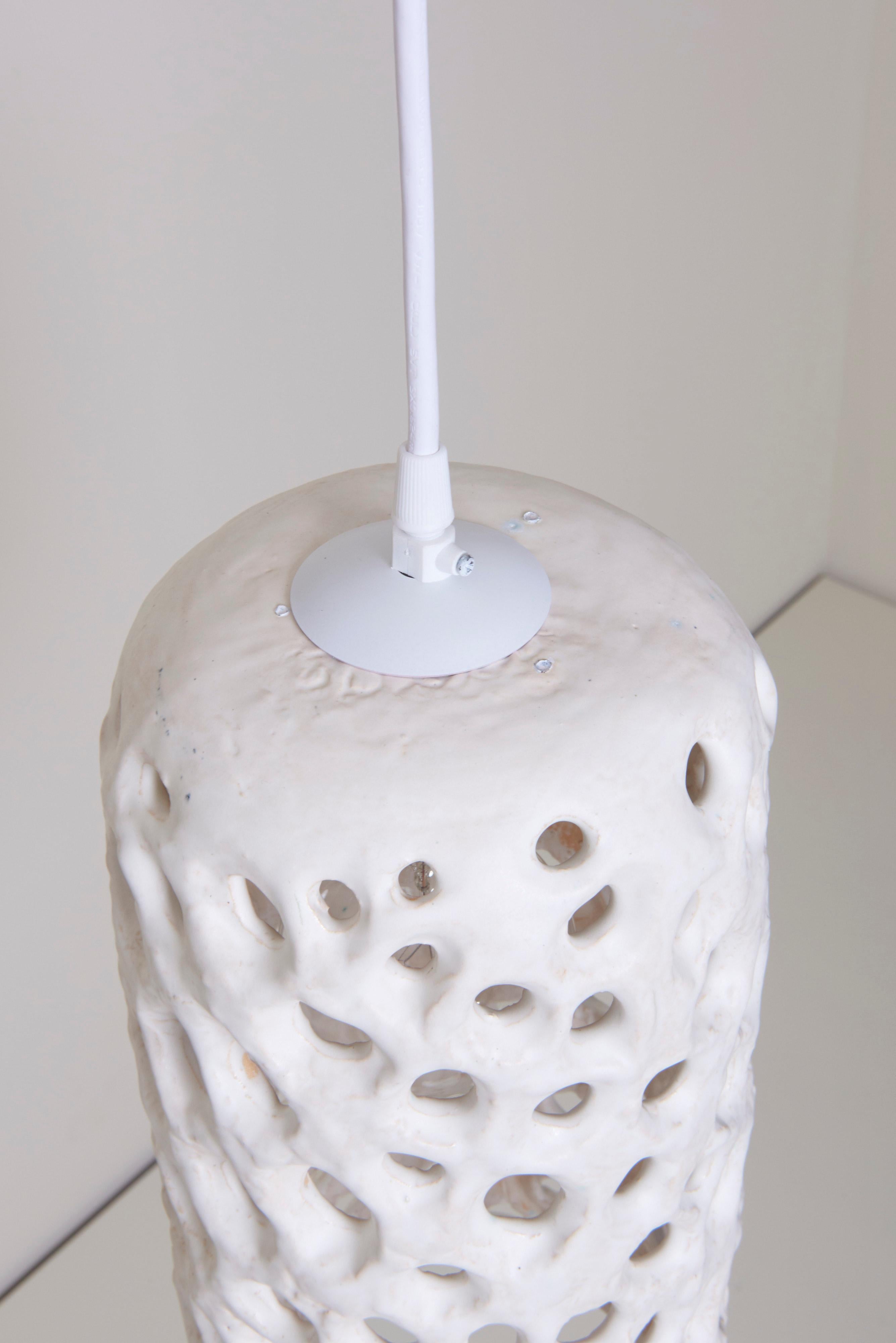 This white lantern in glazed ceramic is handmade by Stan Bitters.
Warm light soaks through the different openings.
One model A / E27 Bulb 40 watts.

To be on the safe side, the lamp should be checked locally by a specialist concerning local
