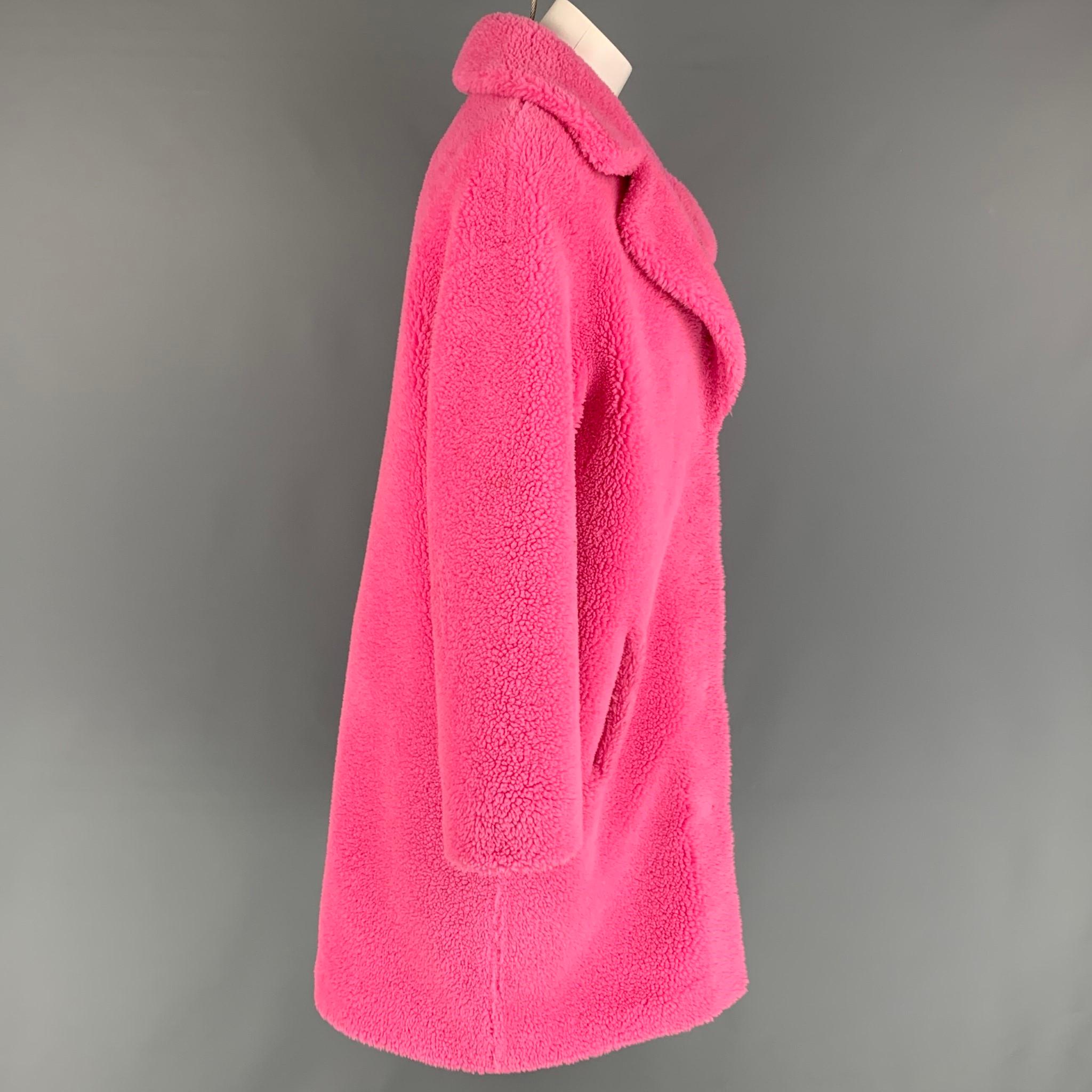 STAND STUDIO coat comes in a pink faux fur featuring a notch lapel, slit pockets, and a hidden snap button closure. 

Very Good Pre-Owned Condition.
Marked: 40

Measurements:

Shoulder: 22 in.
Bust: 40 in.
Sleeve: 21 in.
Length: 39 in. 