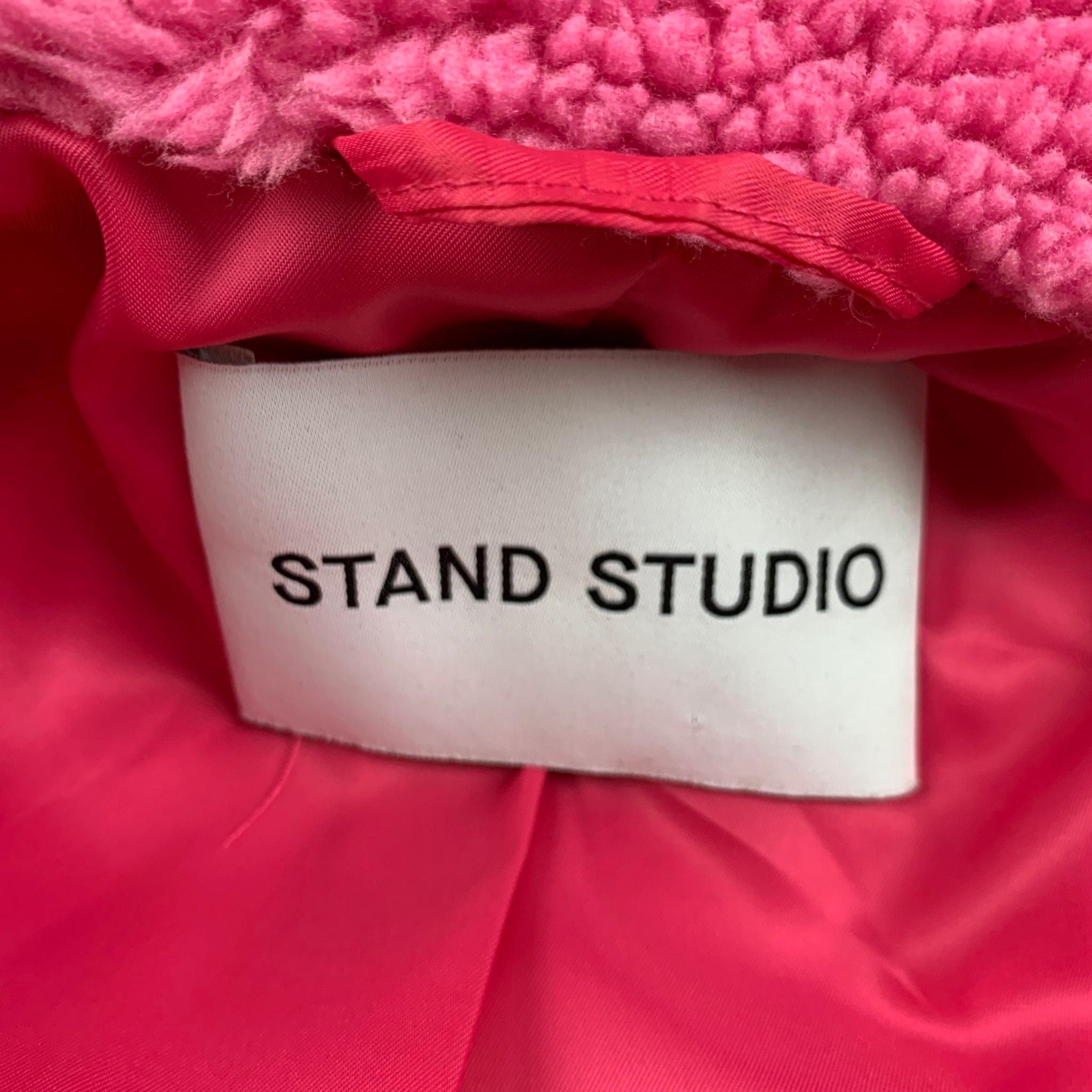 stand studio pink fur coat