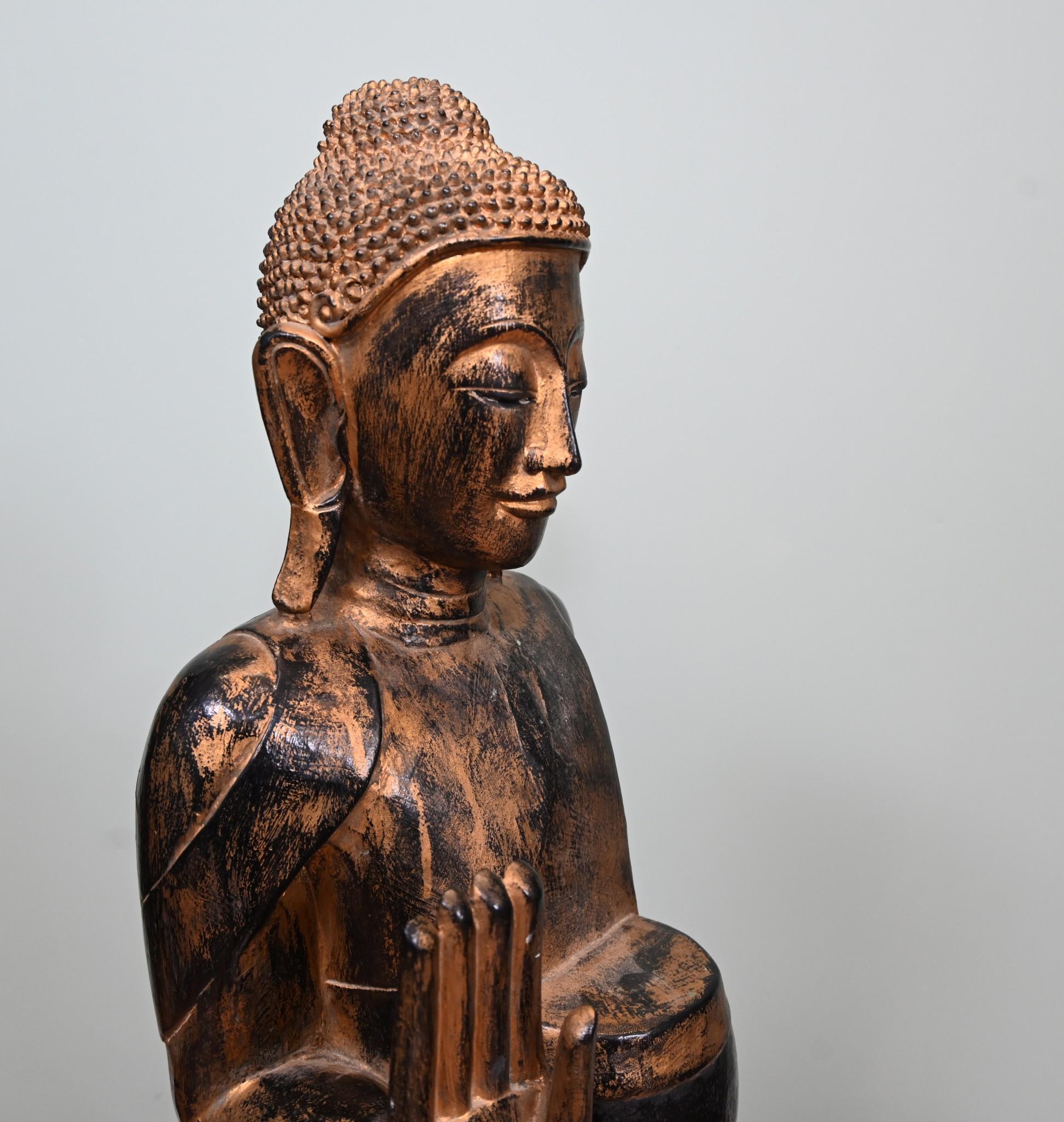 Impressive carved wooden lifesize Burmese buddha statue with its original coloured decorative finish
Circa 1930s
Would add serenity and calm to any interior
Buddha shown carrying a meditation bowl with the other hand held up as a sign of peace
Good