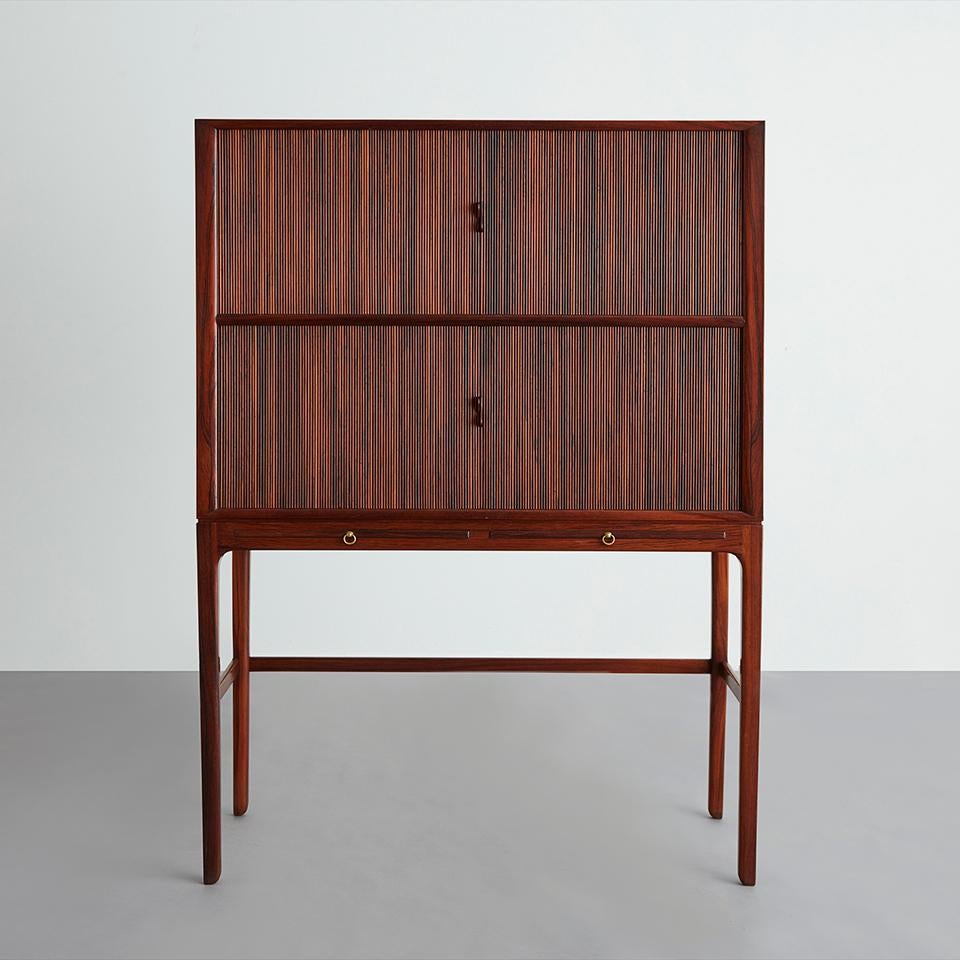 Tambour doors and two pullout shelves. Made by cabinetmaker A.J. Iverson. Brazilian rosewood.