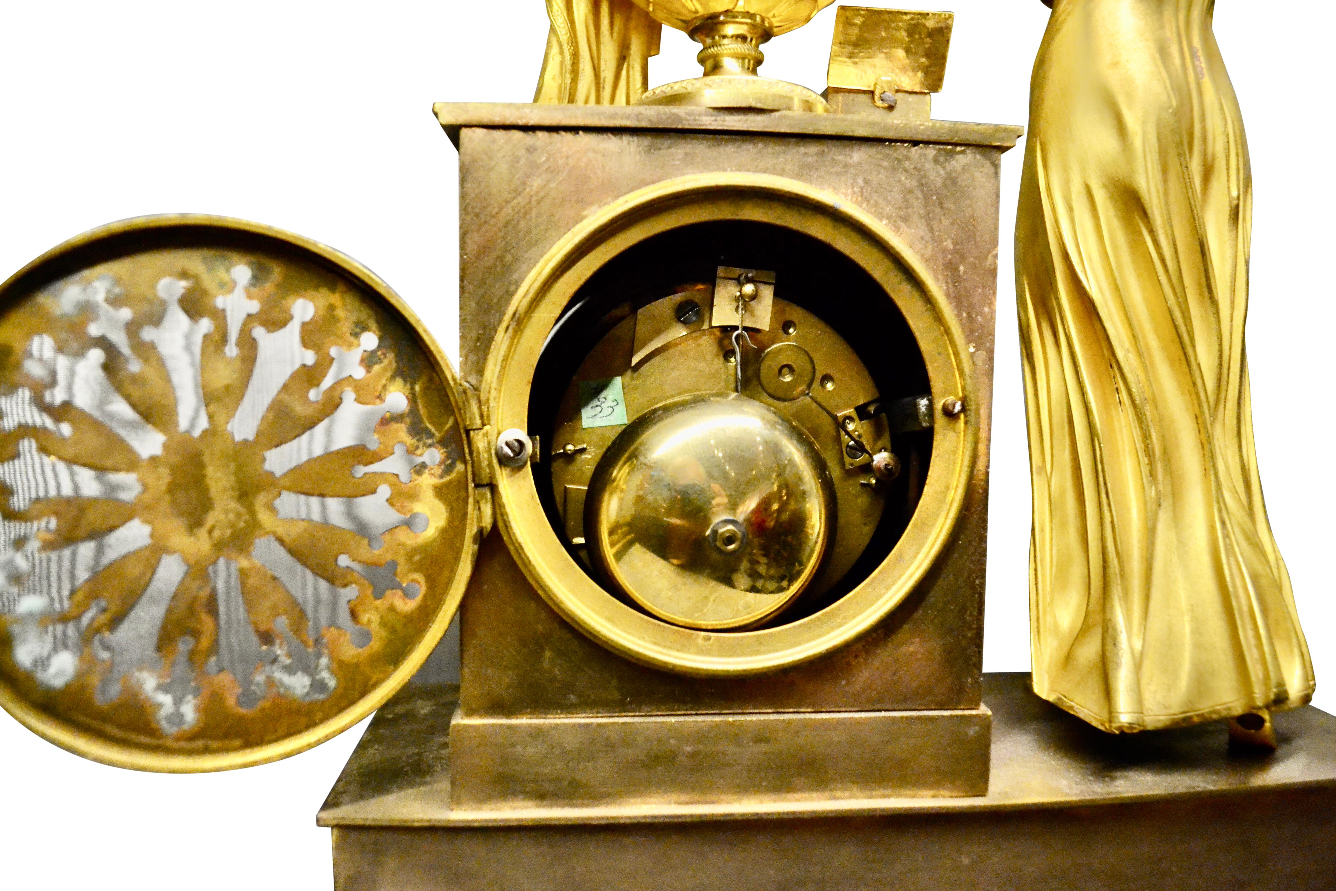 Empire Gilt Bronze  Clock of Standing Classical Lady Unveiling an Urn of Plenty In Good Condition For Sale In Vancouver, British Columbia