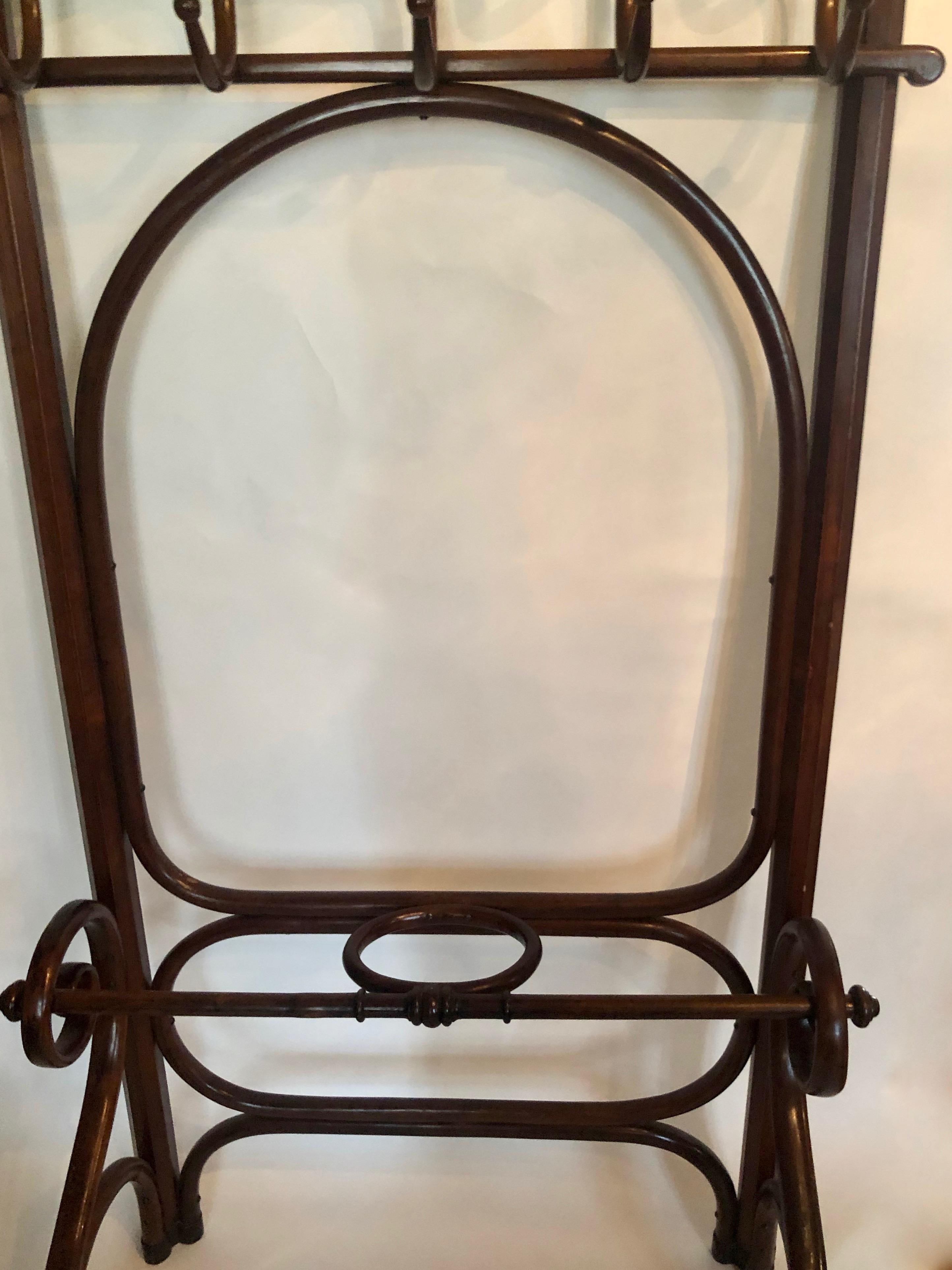 Free standing wardrobe from the Gebrüder Thonet, Wien produced around 1900 . Made from bent beech wood and then stained in a dark colour.
There are five elegantly curved coat hooks that have a double curve for coat and hat; below is a space for