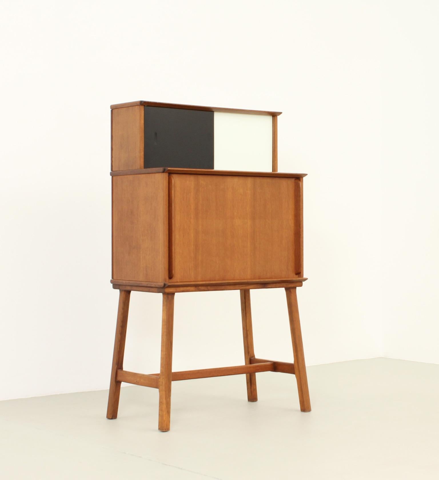 Rare standing desk designed in 1950's by Didier Rozaffy for Meubles Oscar, France. Early edition in oak wood and colored glasses with folding door as a writing desk with storage space inside.