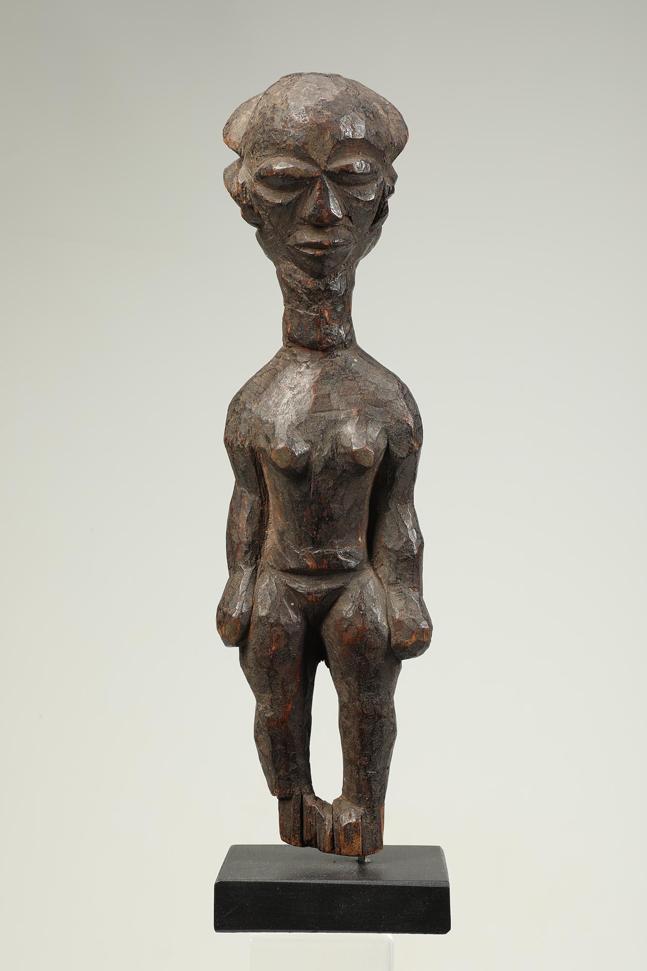 Rare carved wood standing female Pende figure with arms at sides cascading hair.   Classic downturned Pende style face, feet absent.  Democratic Republic of Congo, early to mid-20th century.
Figure is 12 inches high, on custom wood base total height