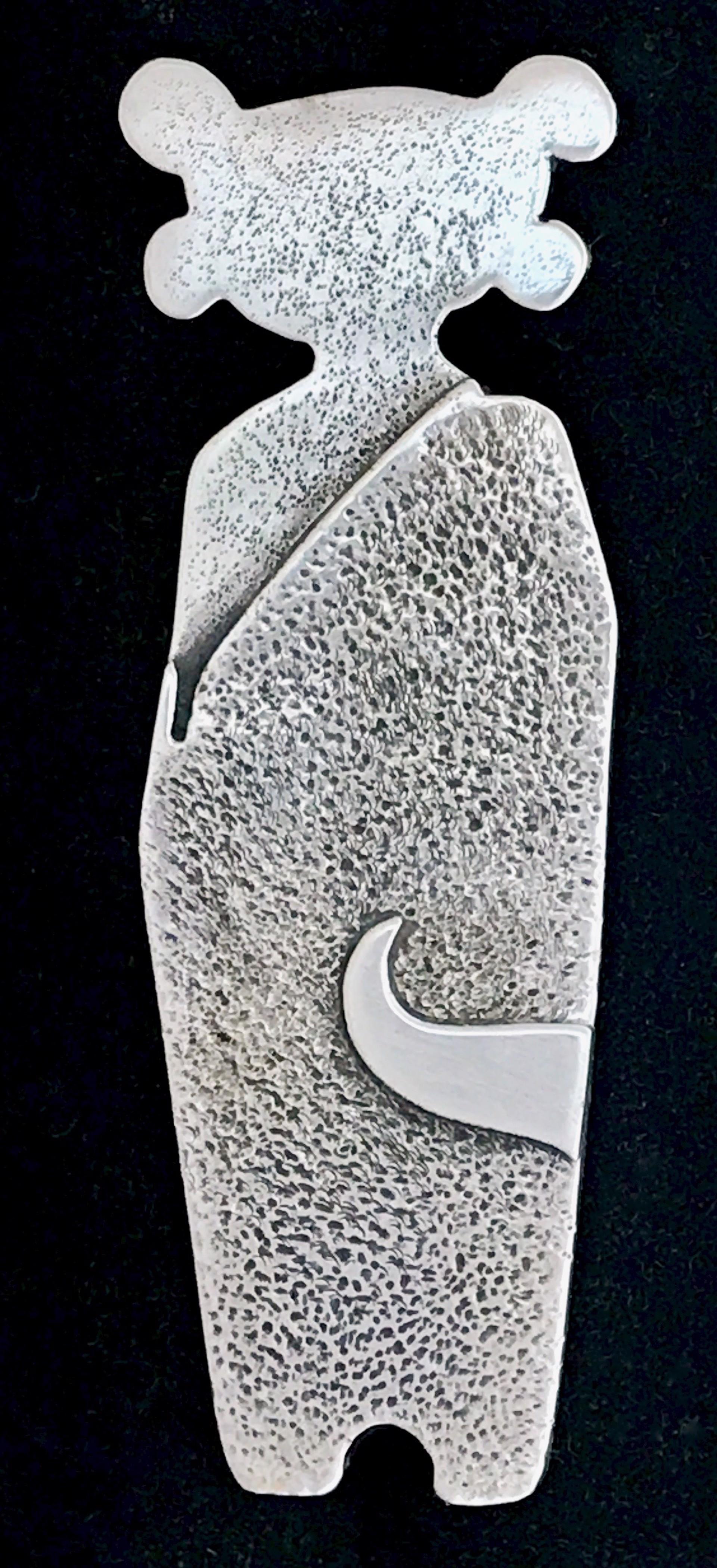 Standing Guard, by Melanie Yazzie, Navajo, Female figure, silver, pendant/enhancer

Melanie A. Yazzie (Navajo-Diné) is a highly regarded multimedia artist known for her printmaking, paintings, sculpture, and jewelry designs. She has exhibited,
