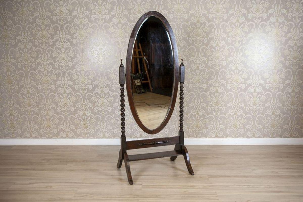 Standing Mirror From the Early 20th Century in Rotating Oak Frame

A large, freestanding, rotating mirror with an oak base and frame, dated to the early 20th century. The beveled glass is set in an oval frame, and the stand is finished with four