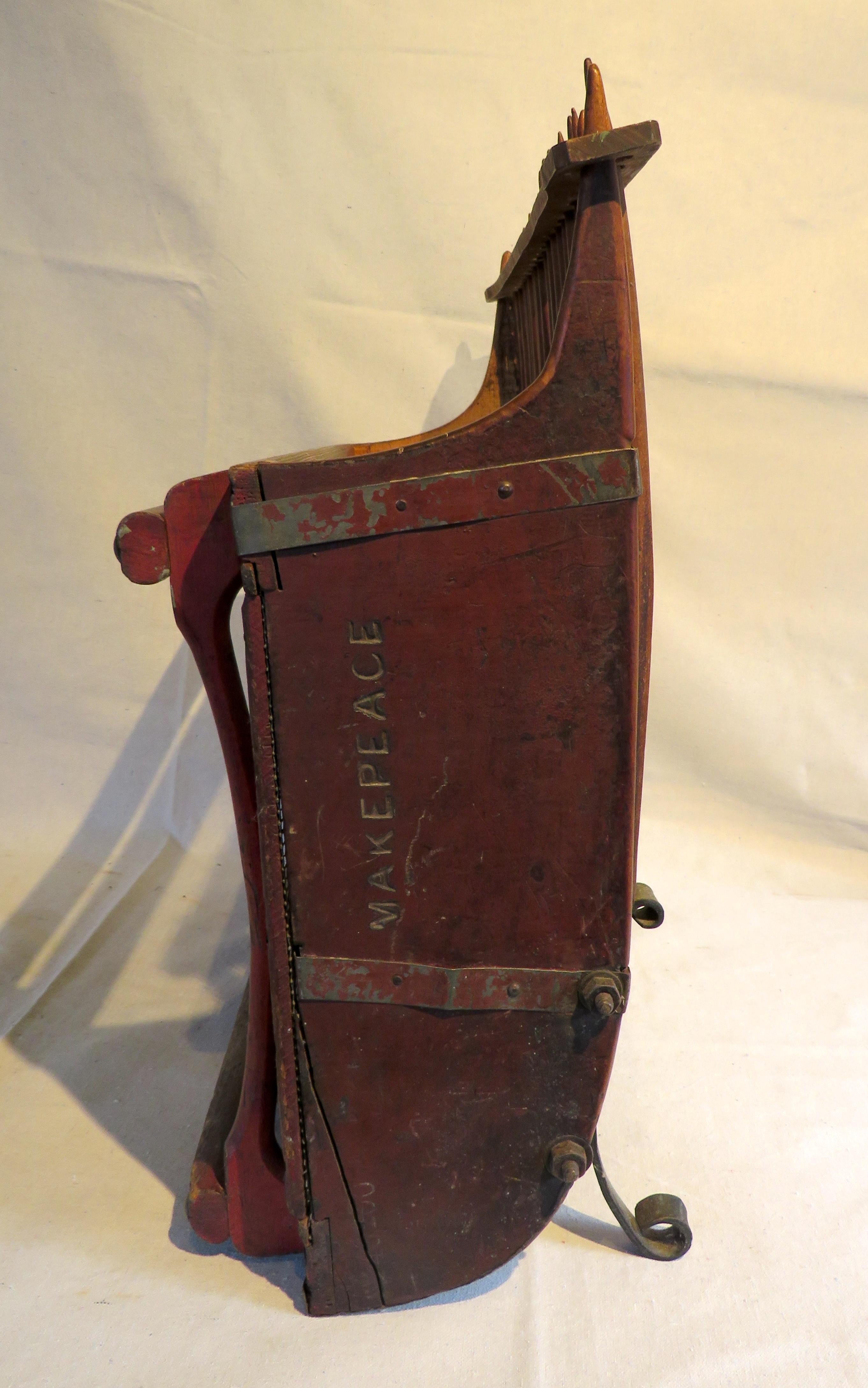 Early 20th century Cape Cod cranberry scoop from Wareham, Massachusetts. In original red paint and tin-lined underside. With later added iron 