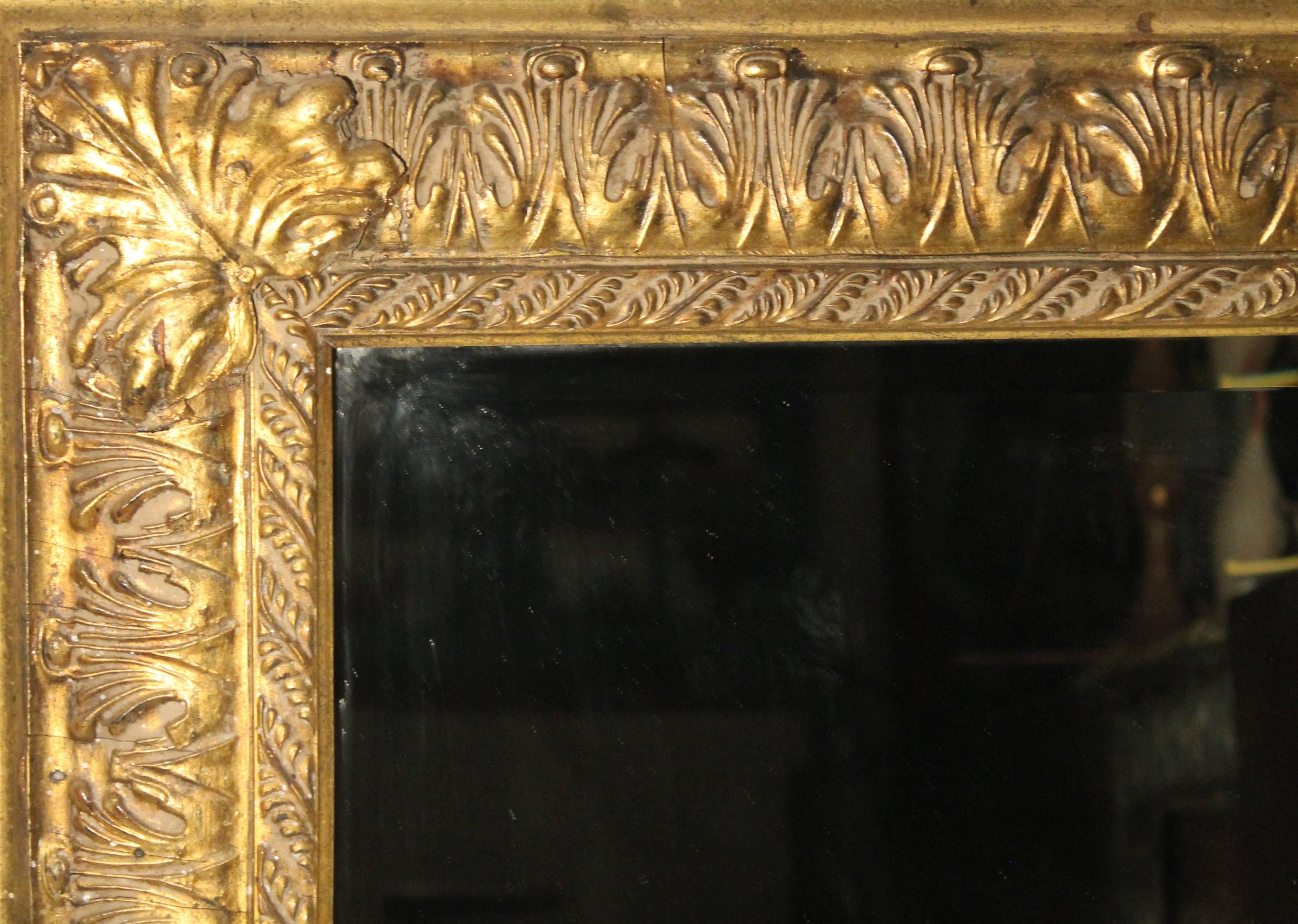 A large frame with a beveled glass mirror. Acanthus leaf decoration. Frame size: 33 1/4