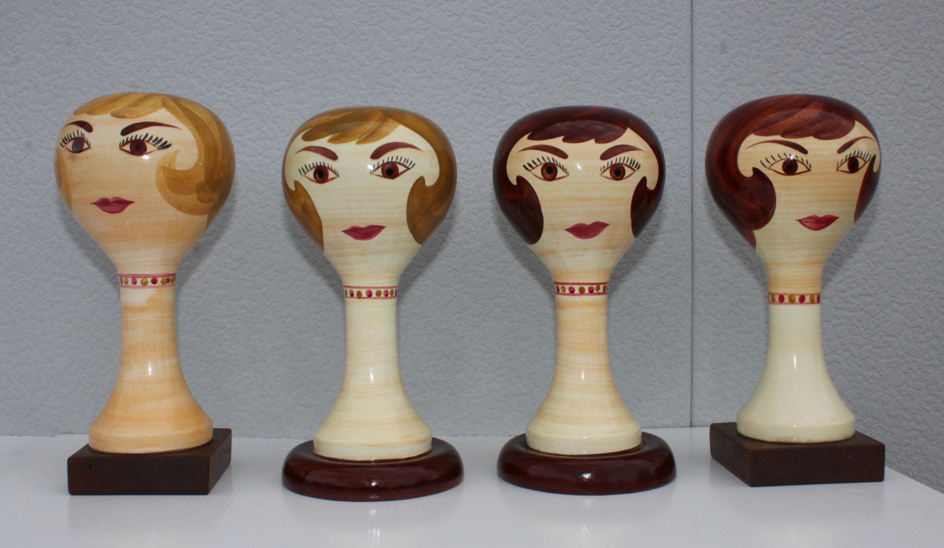 Stunning collection of 4 1960s modernist Stangl pottery hat/wig stands, two of them with wood bases and two with pottery stands.

 