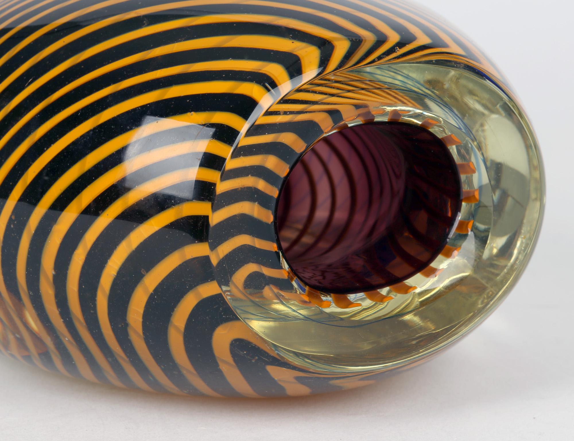 A stunning Czech/Bohemian art glass sculptural vase with encased swirl patterning attributed to Stanislav Liensky (1921-2002) for Beranek Skrdlovice Glassworks and dating from the 1970's. This heavily made blown glass vase stands mounted on square