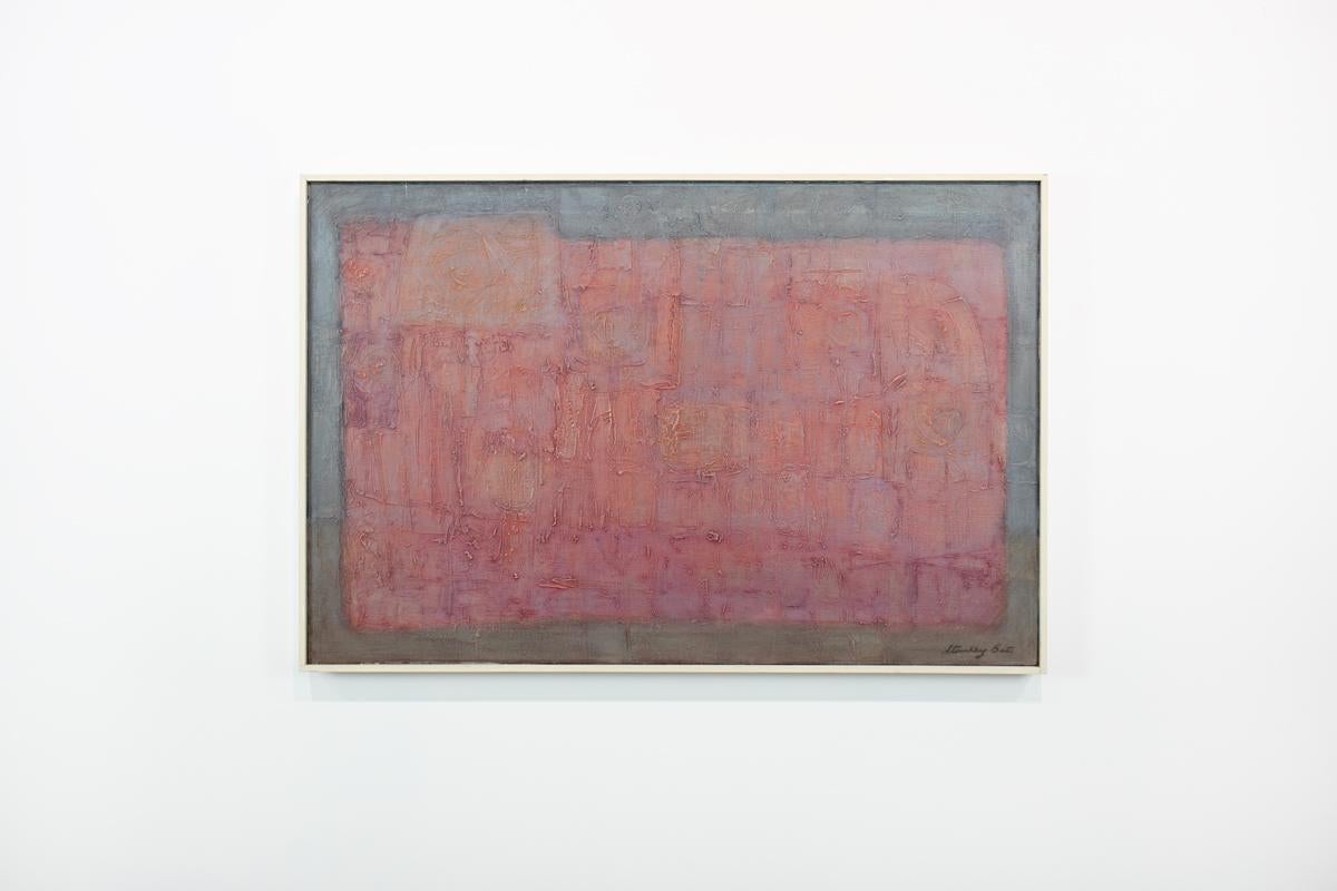 This Modern Abstract Expressionist painting by Stanley Bate is made with oil paint on canvas and features a warm red geometric rectangular shape at the center of the composition, with deep grey and umber tones surrounding it on the outer edge. The
