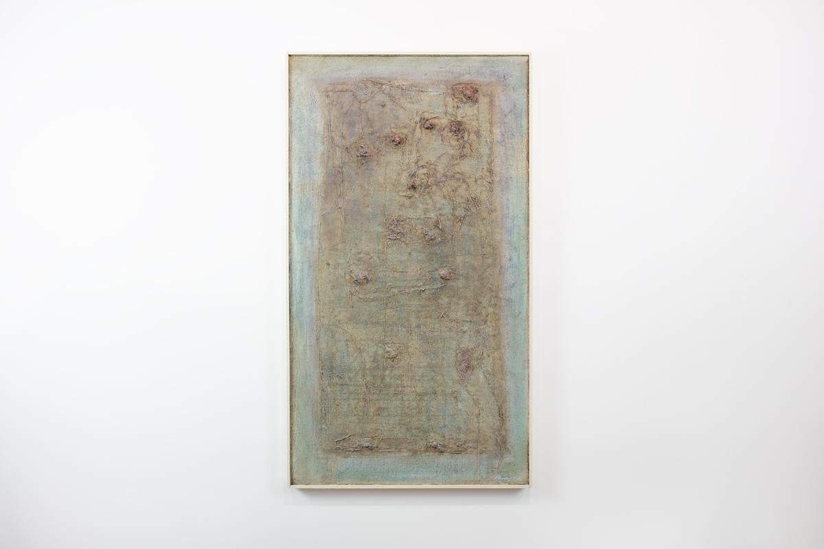 This Modern Abstract Expressionist painting by Stanley Bate is made with oil paint on board and features an earth-toned palette. The artist layers paint on the canvas, creating texture among softly blended muted green and umber colors in a highly