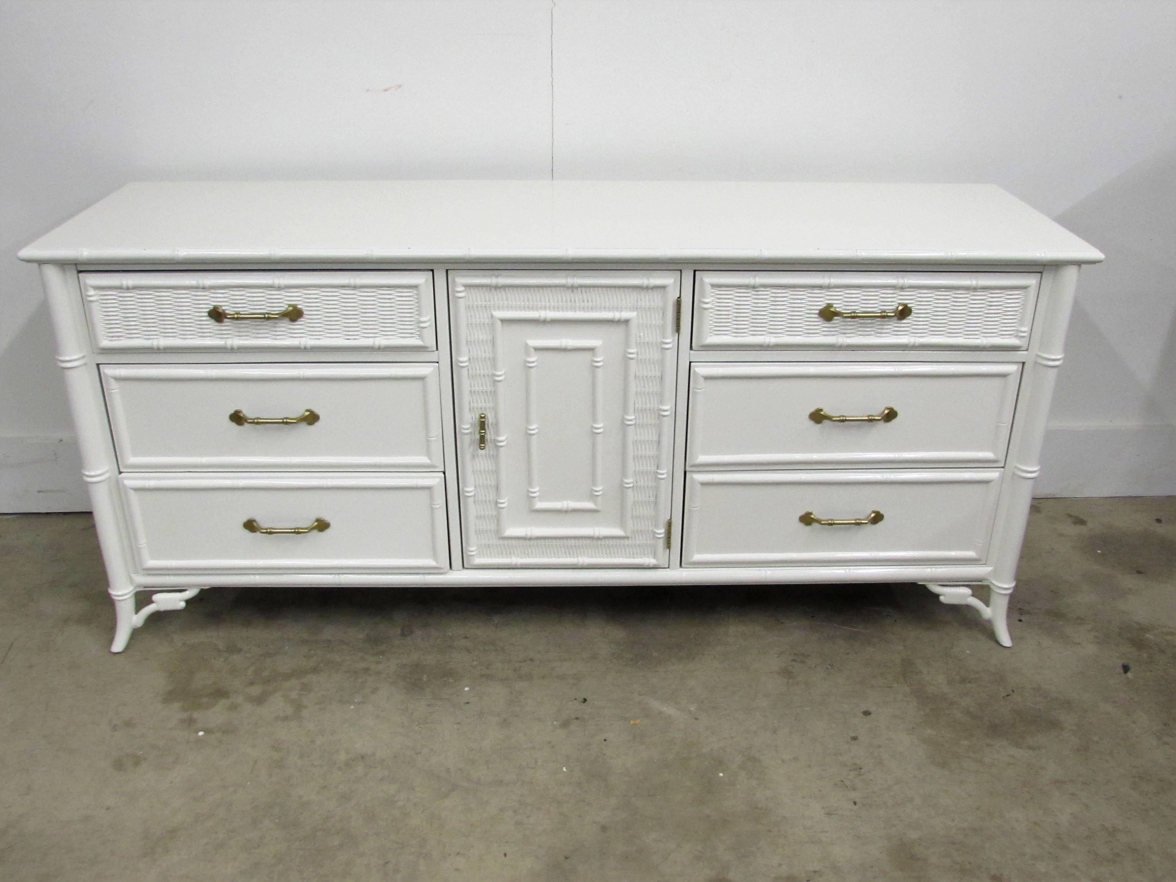 Stanley faux bamboo chest of drawers lacquered in-house in alabaster white gloss finish with nine dovetail drawers with woven and faux bamboo accents, three sets of drawers on each side of one swinging door that open to three additional drawers, two