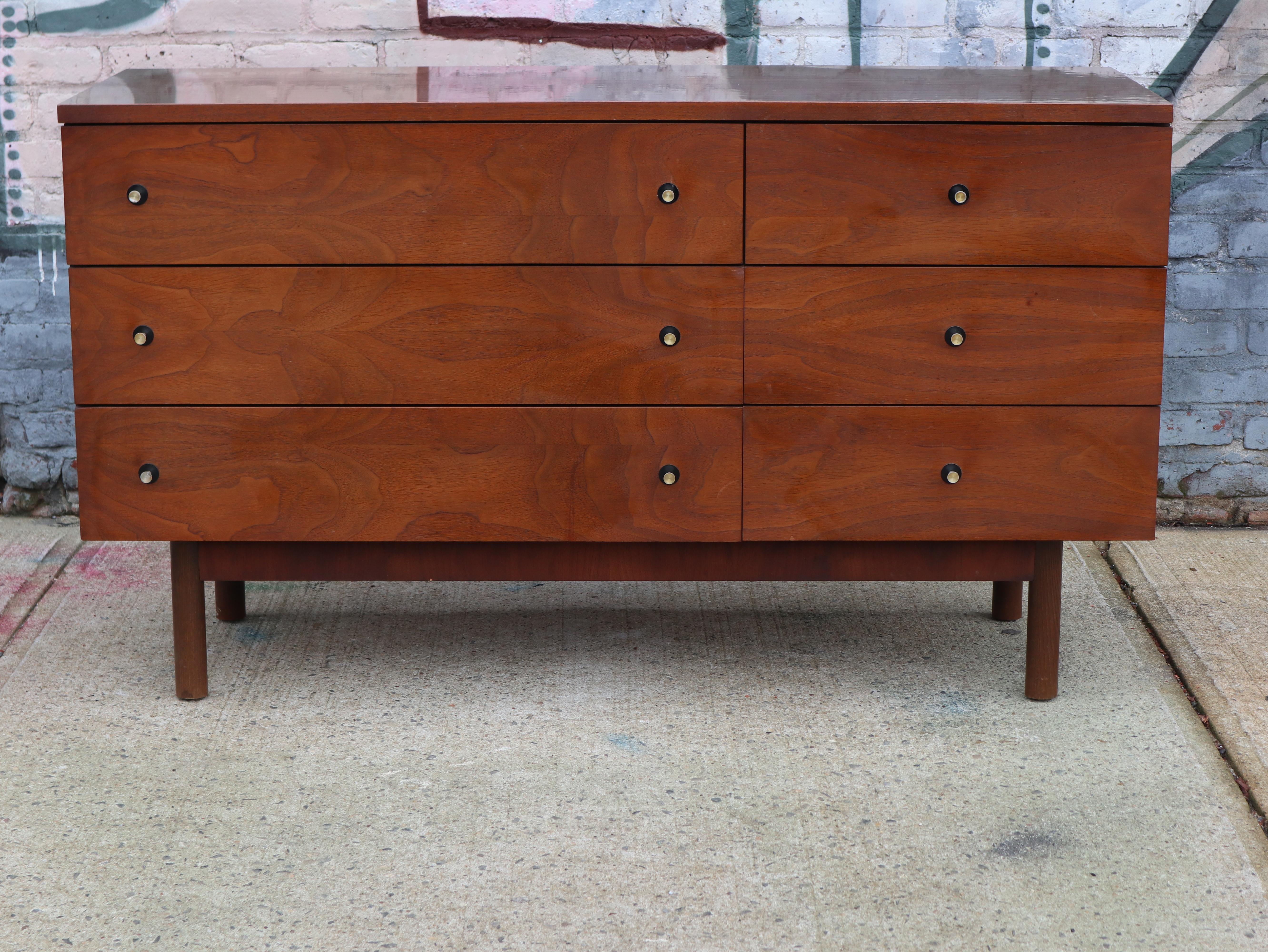 Beautiful walnut dresser by Stanley Furniture Company. Solid build, very sturdy. Signed inside drawer. Walnut exterior on rounded dowel legs. Laminate walnut grain top. In great condition with original metal pulls. Perfect for several uses including
