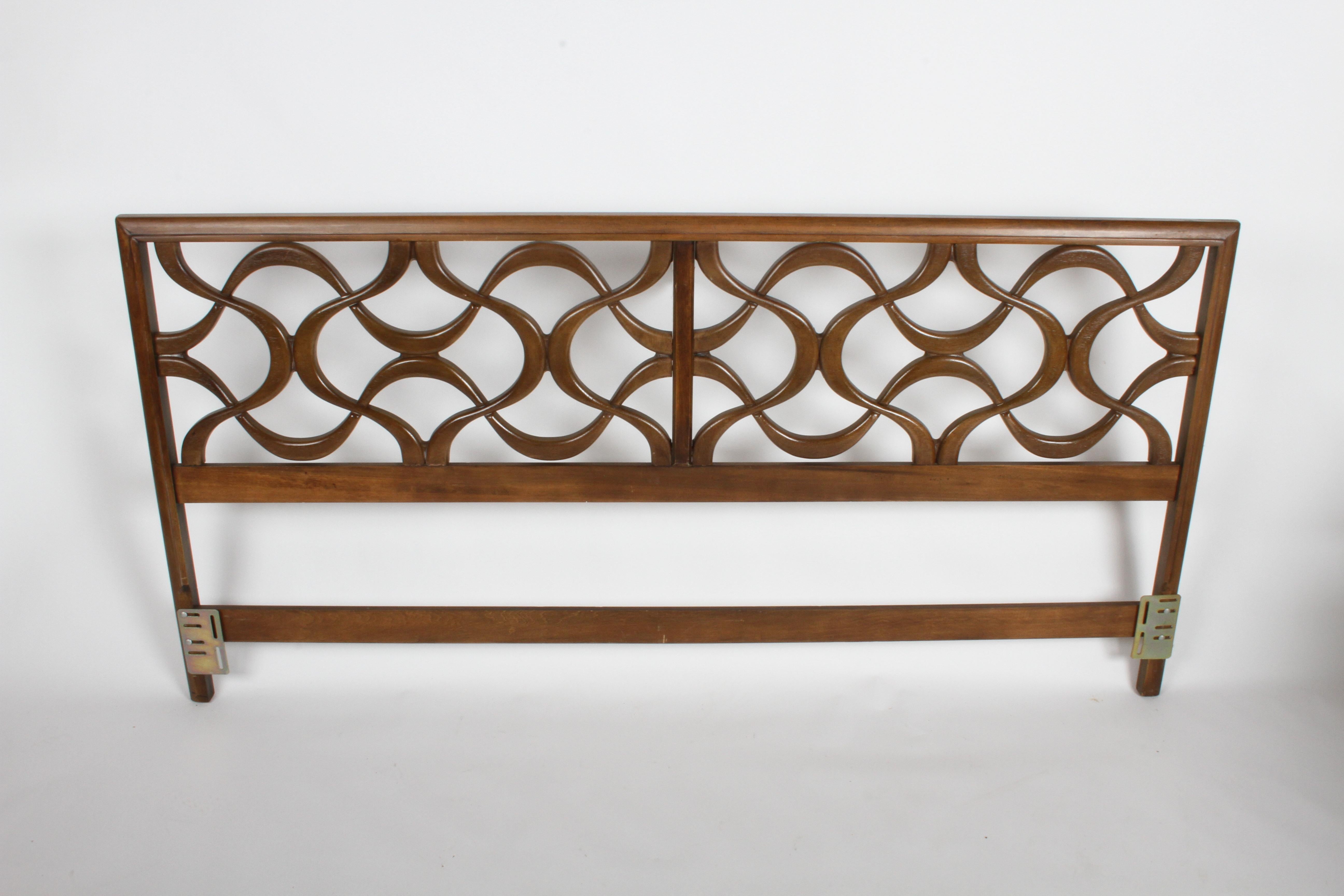 In the style of Erwin Hauer Continua series, sculptural interlocking geometric form king size headboard in original medium pecan finish. The sculptural interlocking hourglass forms are made of a resin composite, framed by walnut. Headboard will be