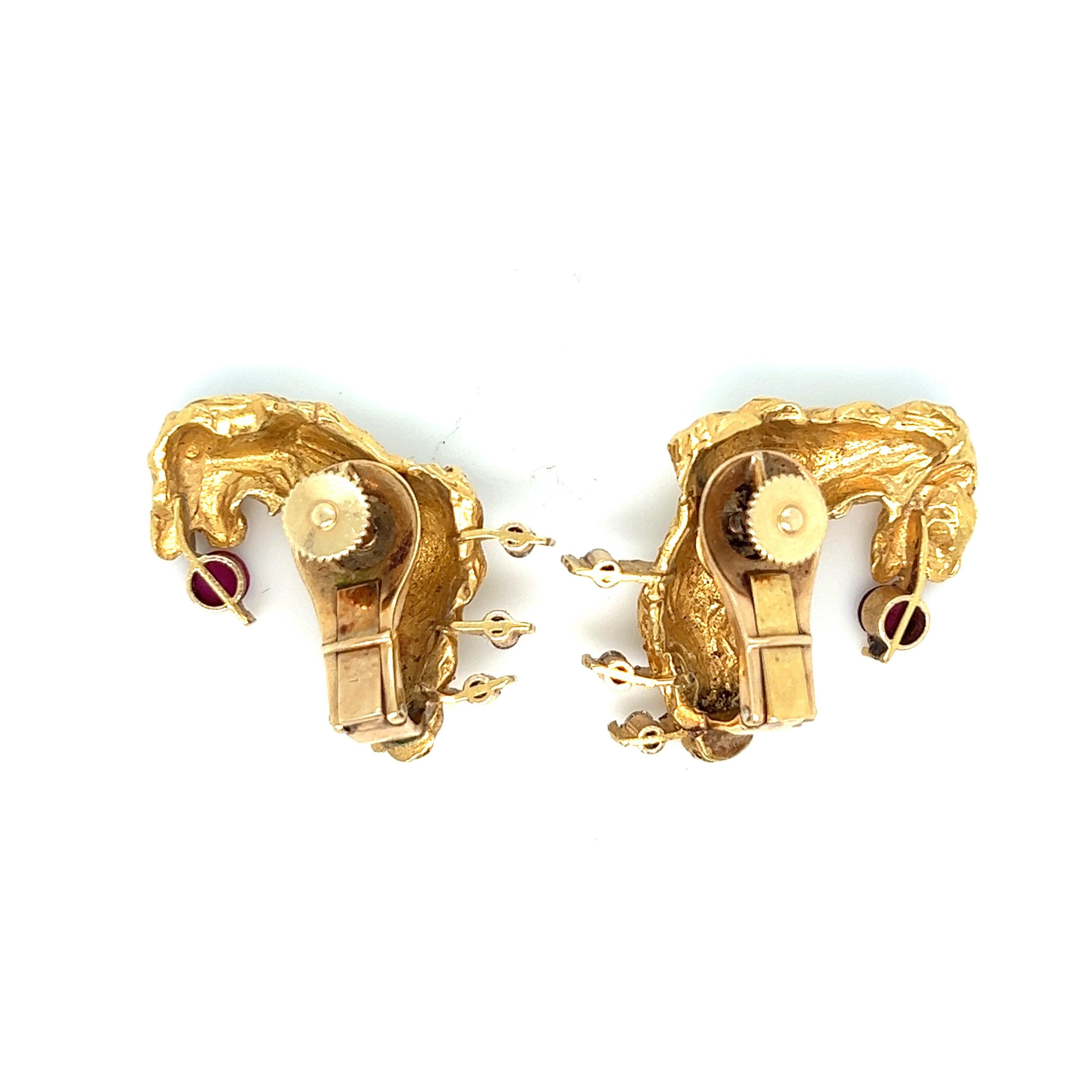 Stanley Lechtzin gold ruby diamond ear clips 

Of abstract form, set with circular-cut rubies of approximately 0.40 carat and full-cut diamonds of approximately 0.18 carat; 18 karat yellow gold

Marked Lechtzin, 18K 

Size: width 1 inch, length 1