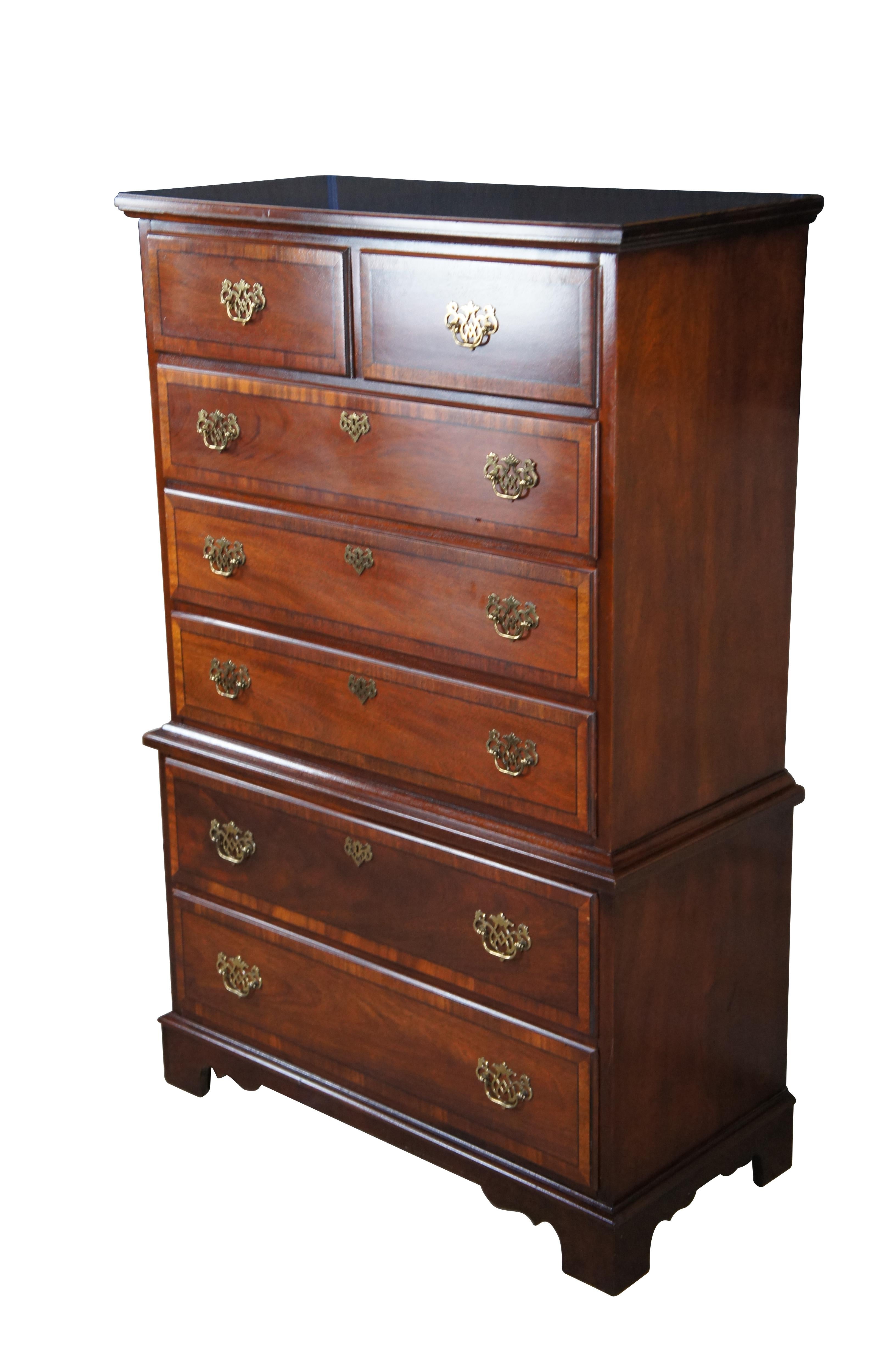 Stanley Stoneleigh Chest of drawers, circa last quarter 20th Century.  Features a Chippendale style frame in mahogany with a chest on chest form.  Includes seven dovetailed drawers with crossbanding, interlaced brass bail hardware and faux