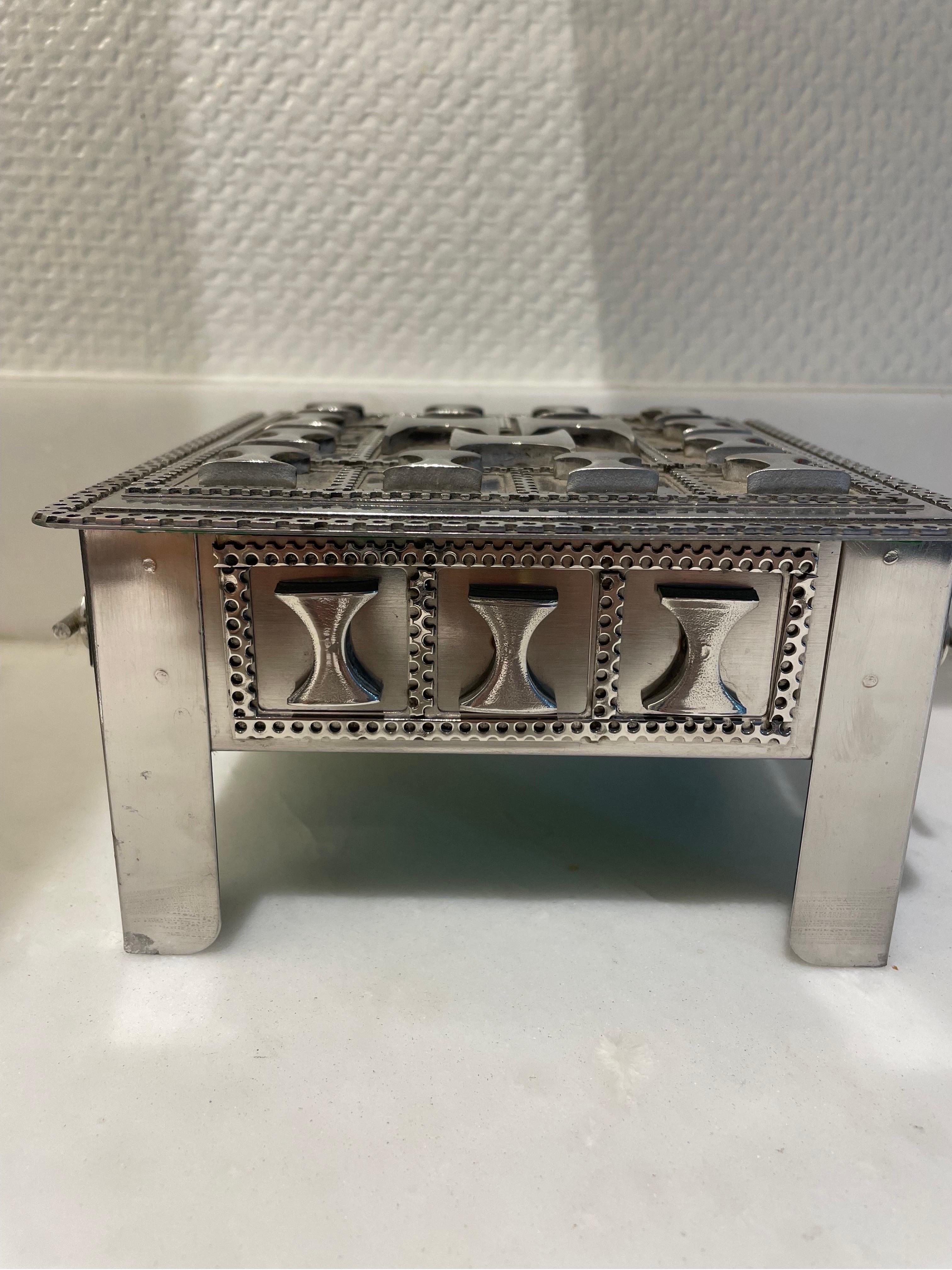 This is a cool geometric adorned stainless steel scrap metal box made by a polish immigrant folk artist Stanley Szwarc in 1999 