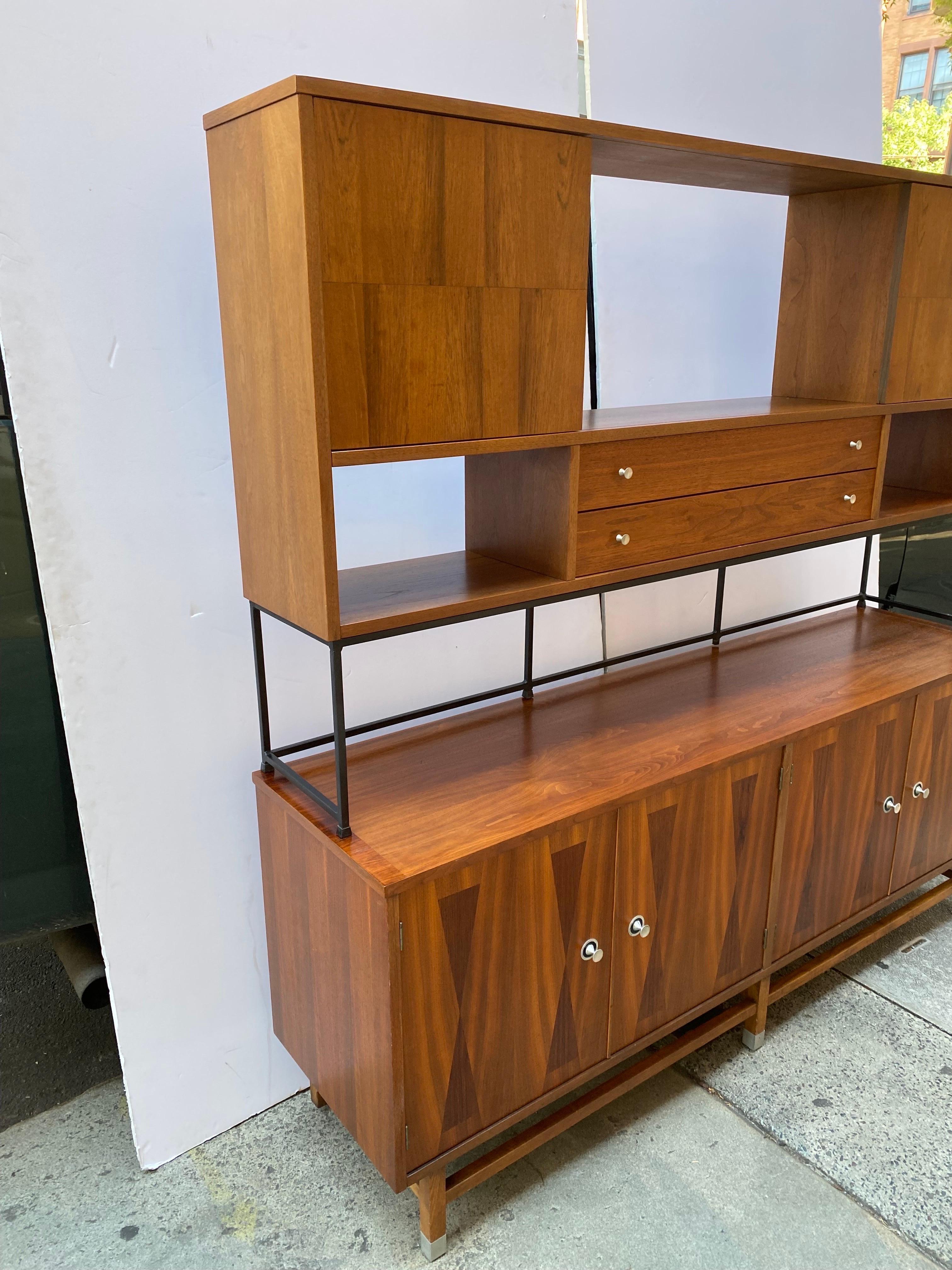 This Mid-Century Modern 2-piece credenza or sideboard by Stanley is functional and beautifully detailed for display and storage in a living or dining room. The cabinets are of walnut with geometric rosewood inlays on the fronts and turned aluminum