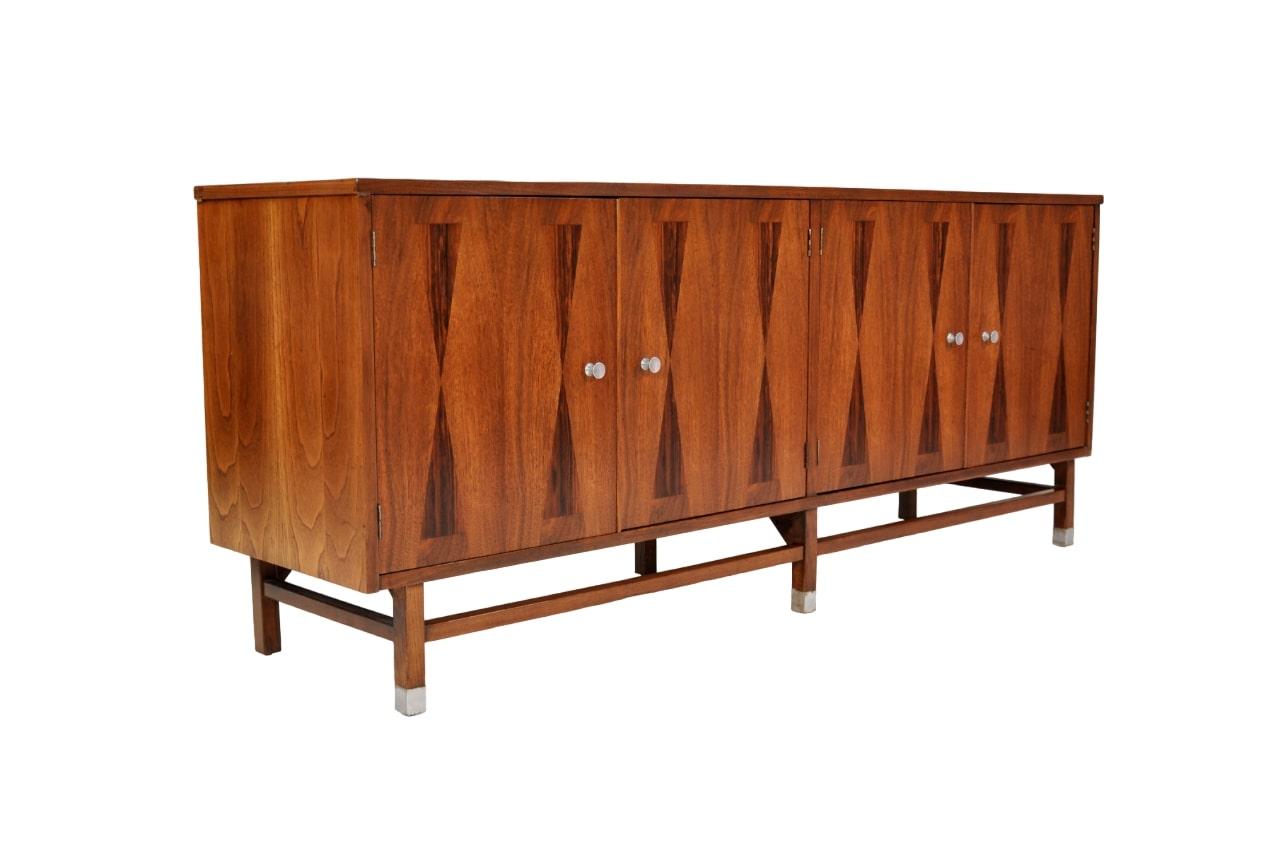 Gorgeous Mid-Century Modern bar cabinet from Stanley's Linear Precision Group, circa mid-1960s. The vintage sideboard features a top with rosewood banding and four doors with hourglass rosewood marquetry inlaid fronts, opening to an interior fitted